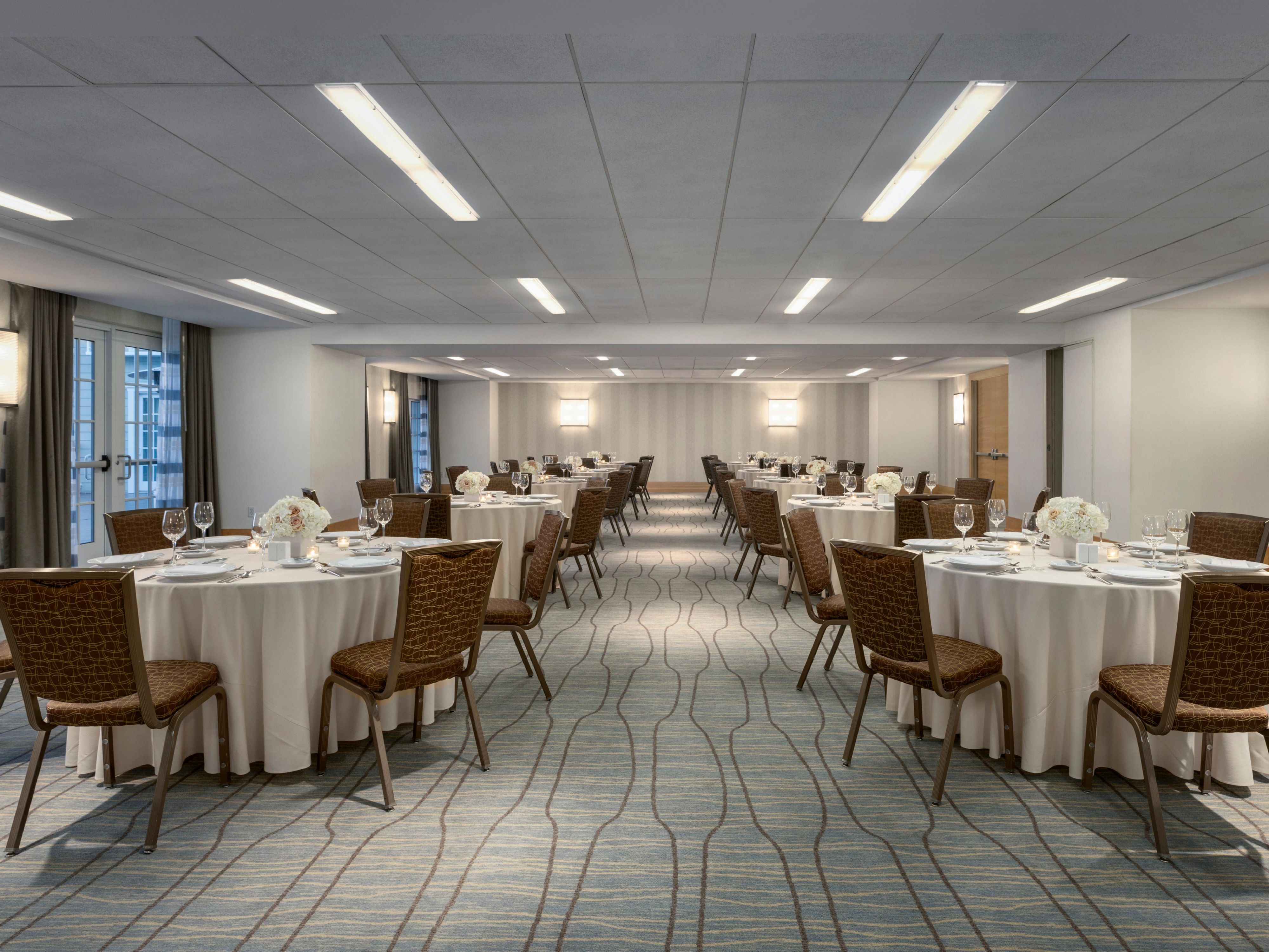 Ocean Terrace Ballroom set up with round tables for an event.