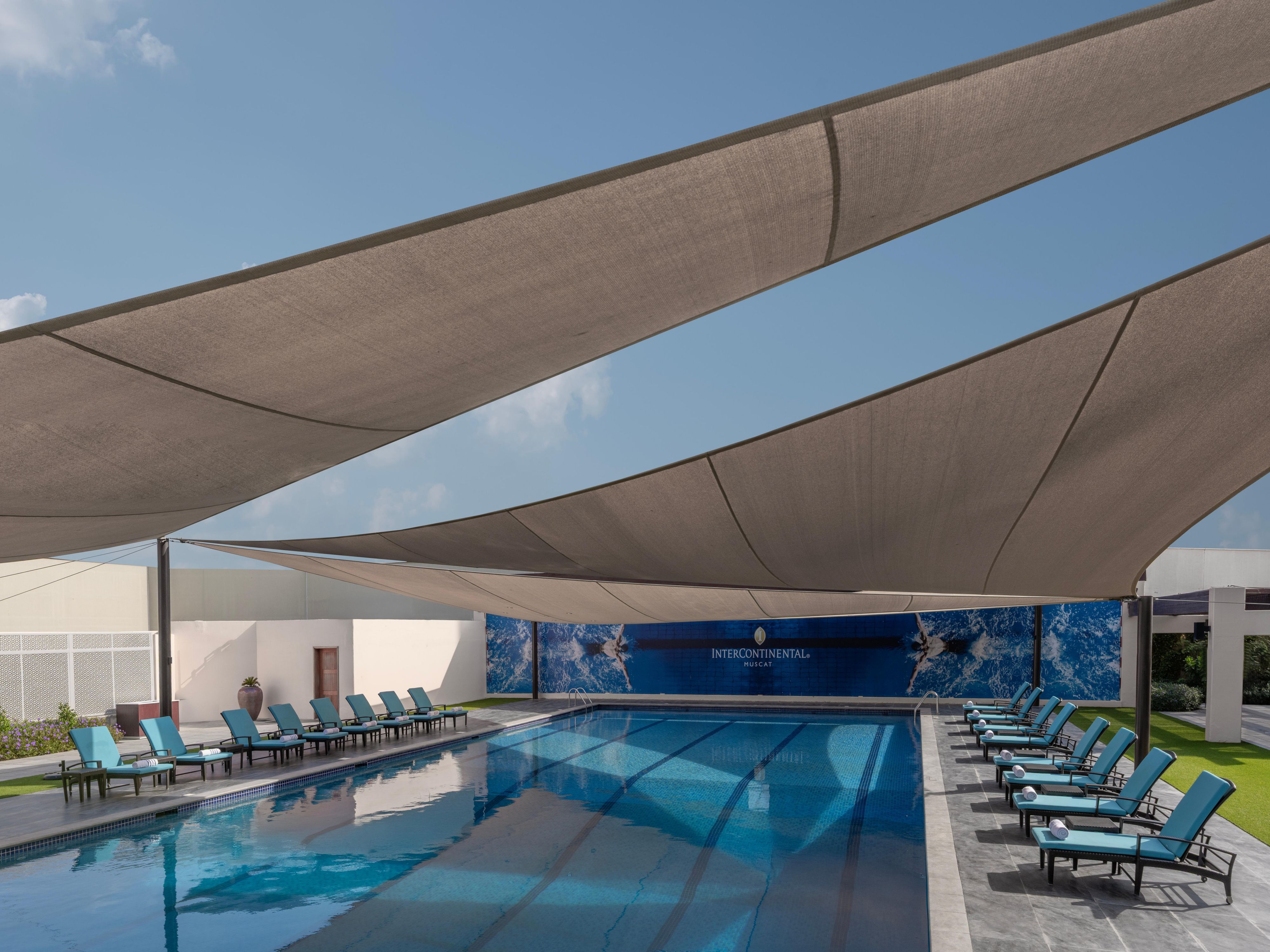 Luxury swimming pool with shaded loungers