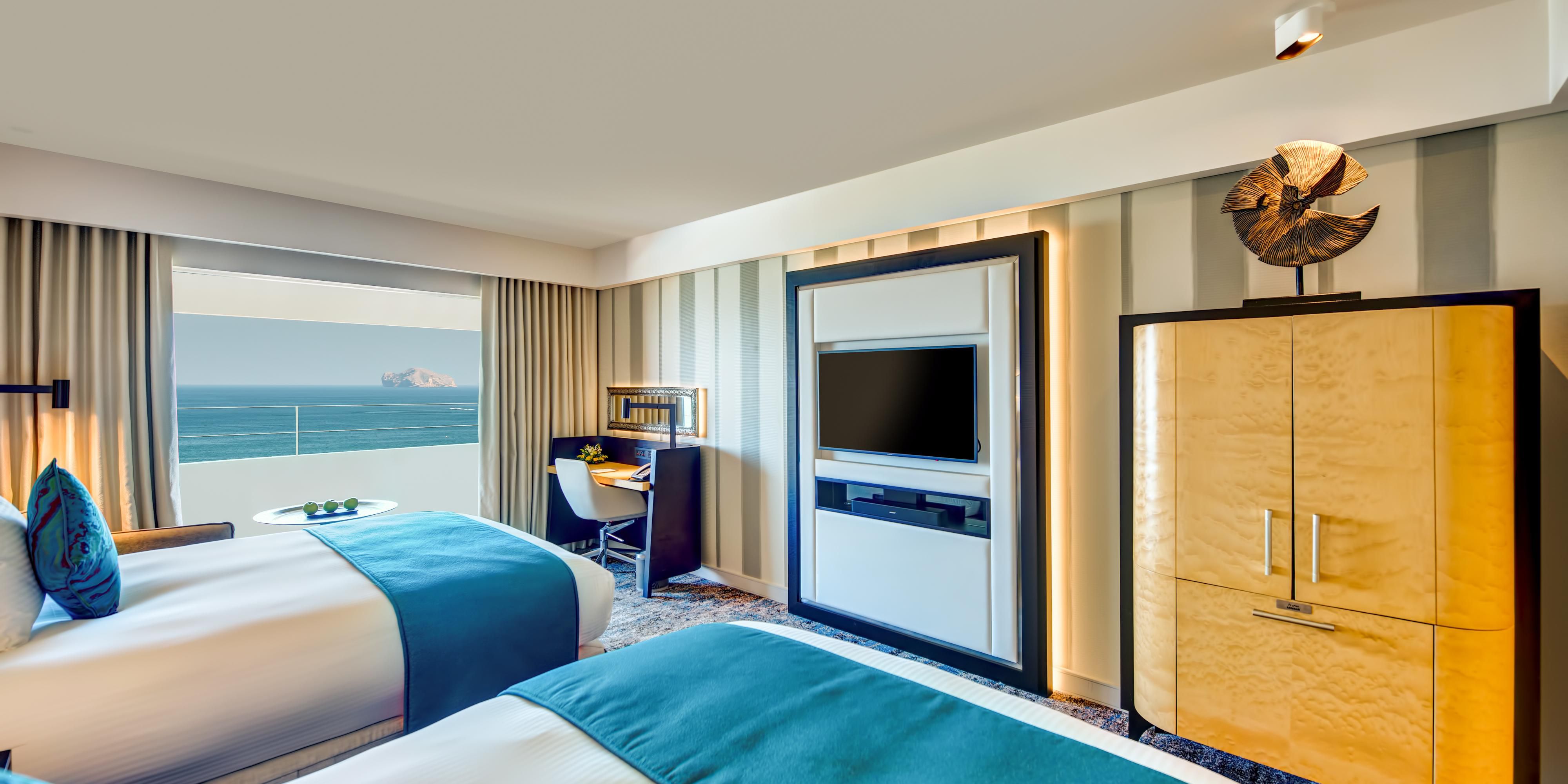 Whether reserving a deluxe guestroom or a suite, guests are welcomed by elegant accommodations with breathtaking views and impeccable service overlooking the majestic Hajjar Mountains, the azure Gulf of Oman, lush gardens, or sparkling swimming pools. For an unparalleled experience, book the two-bedroom Royal Suite. 
