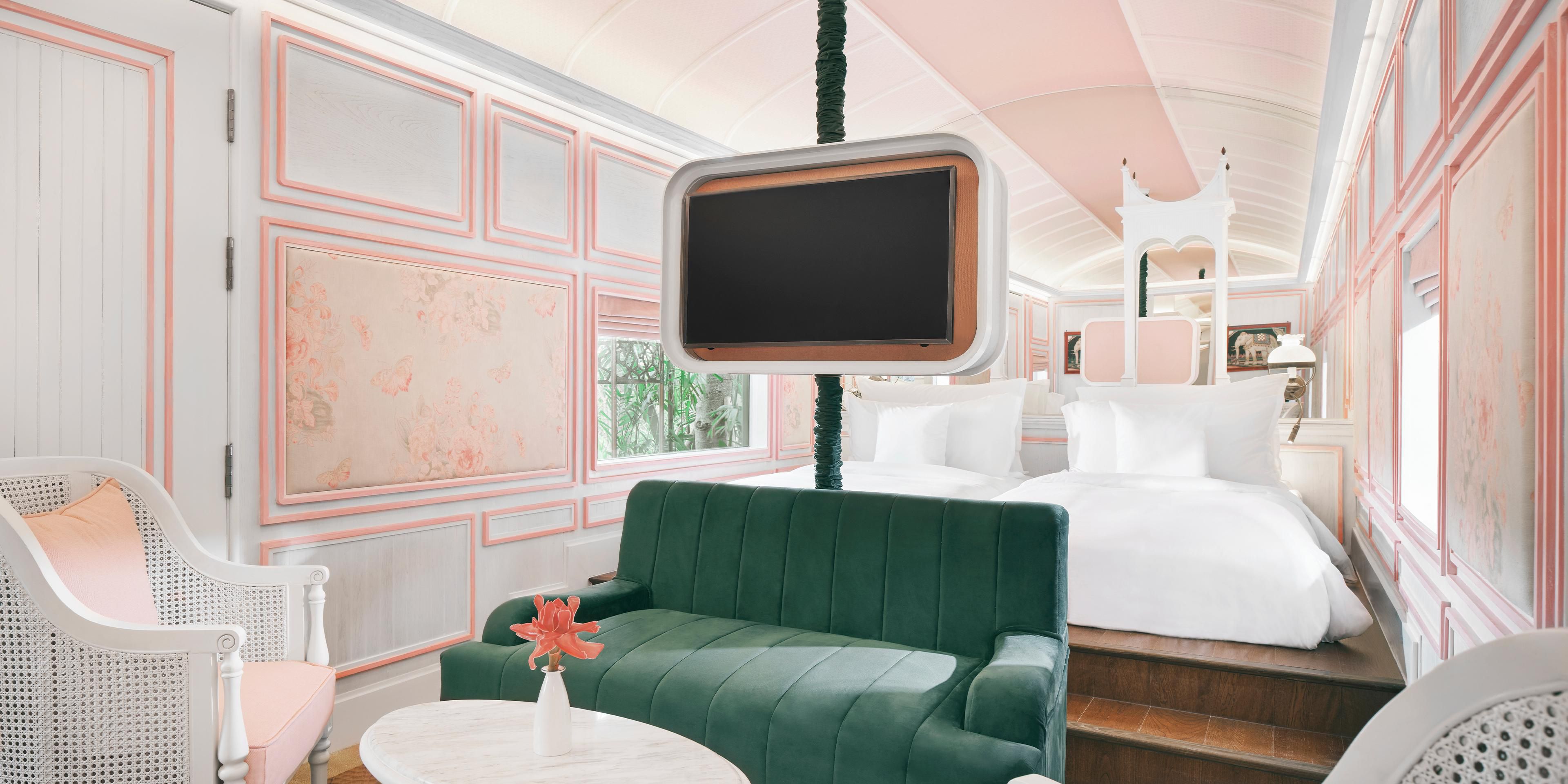 A living room, television and bedroom of Heritage Railcar 2Bedroom