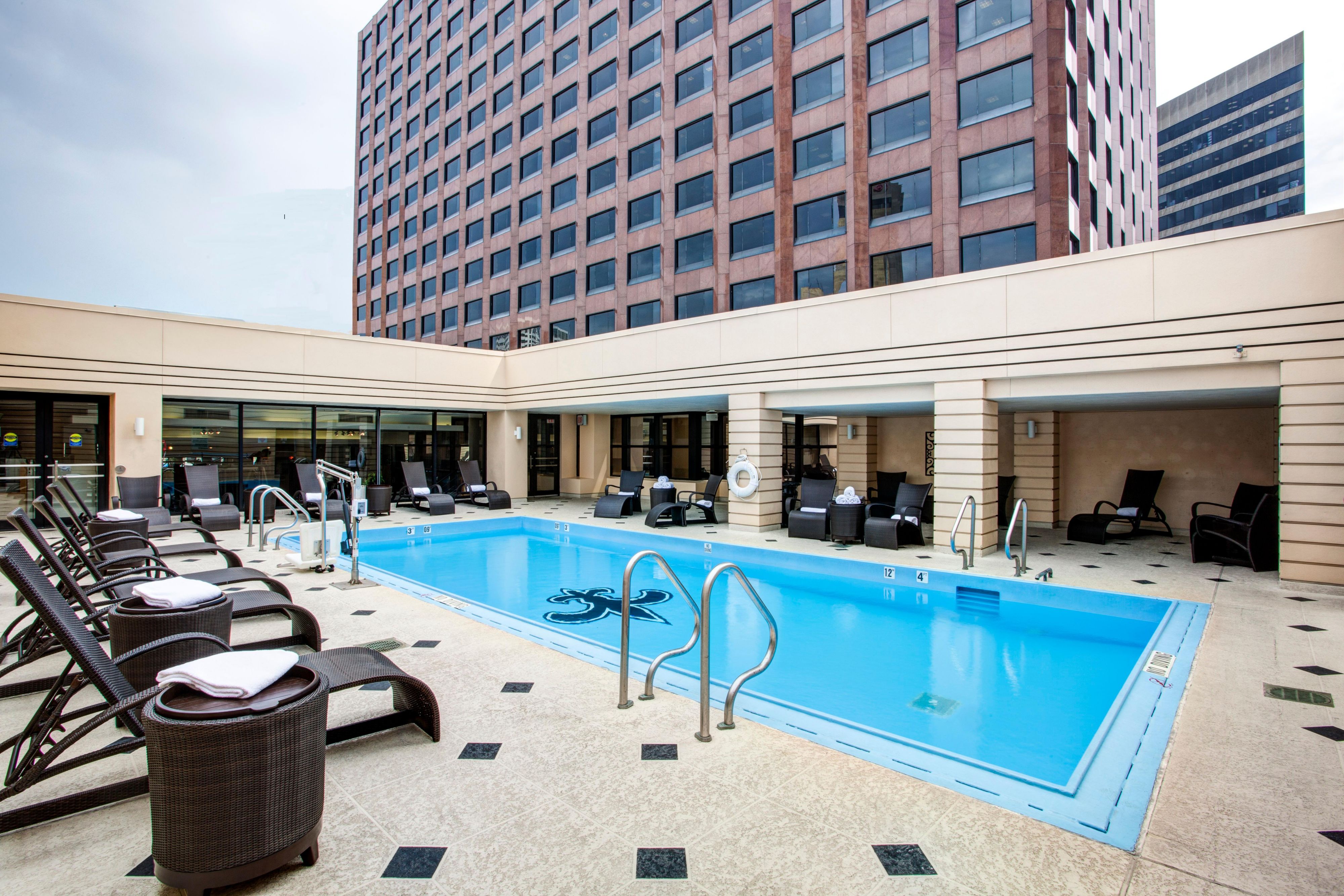 Rooftop swimming pool with lounge chairs at a downtown hotel