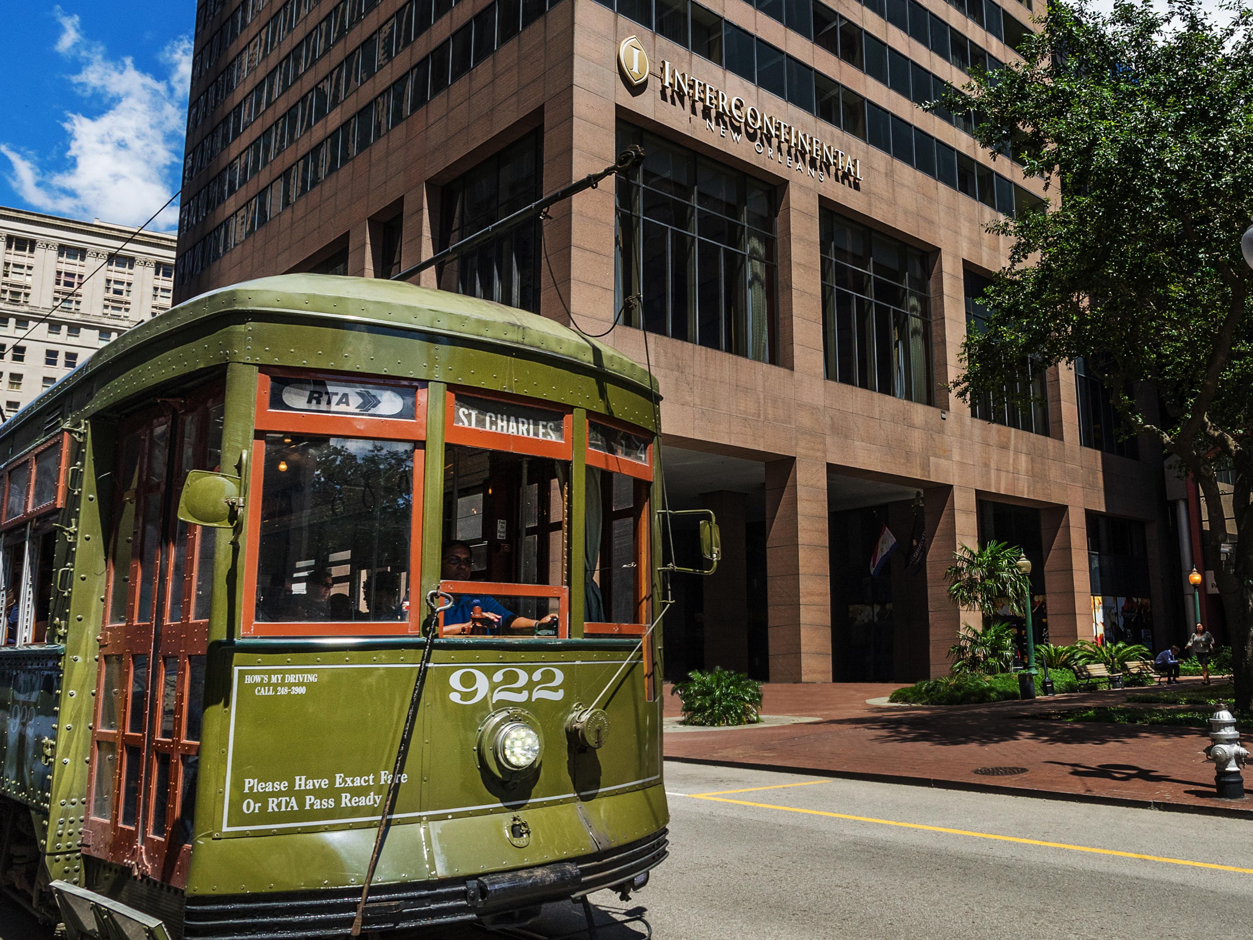 Exterior of the InterContinental New Orleans hotel with streetcar