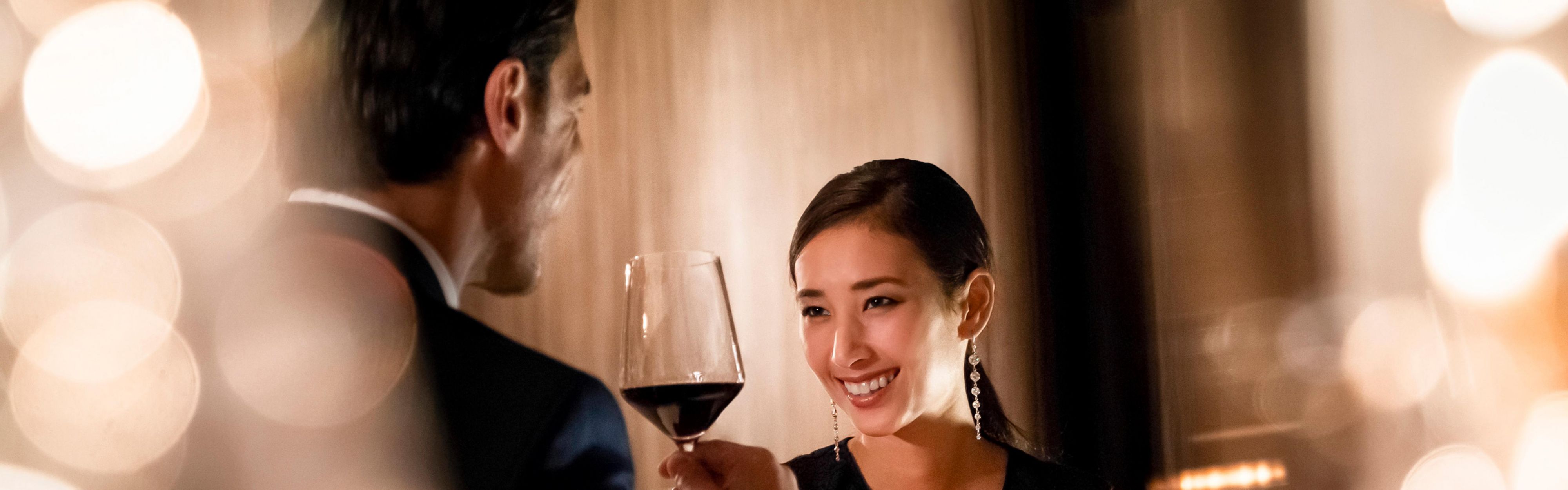 Couple enjoying wine and conversation in an elegant restaurant setting
