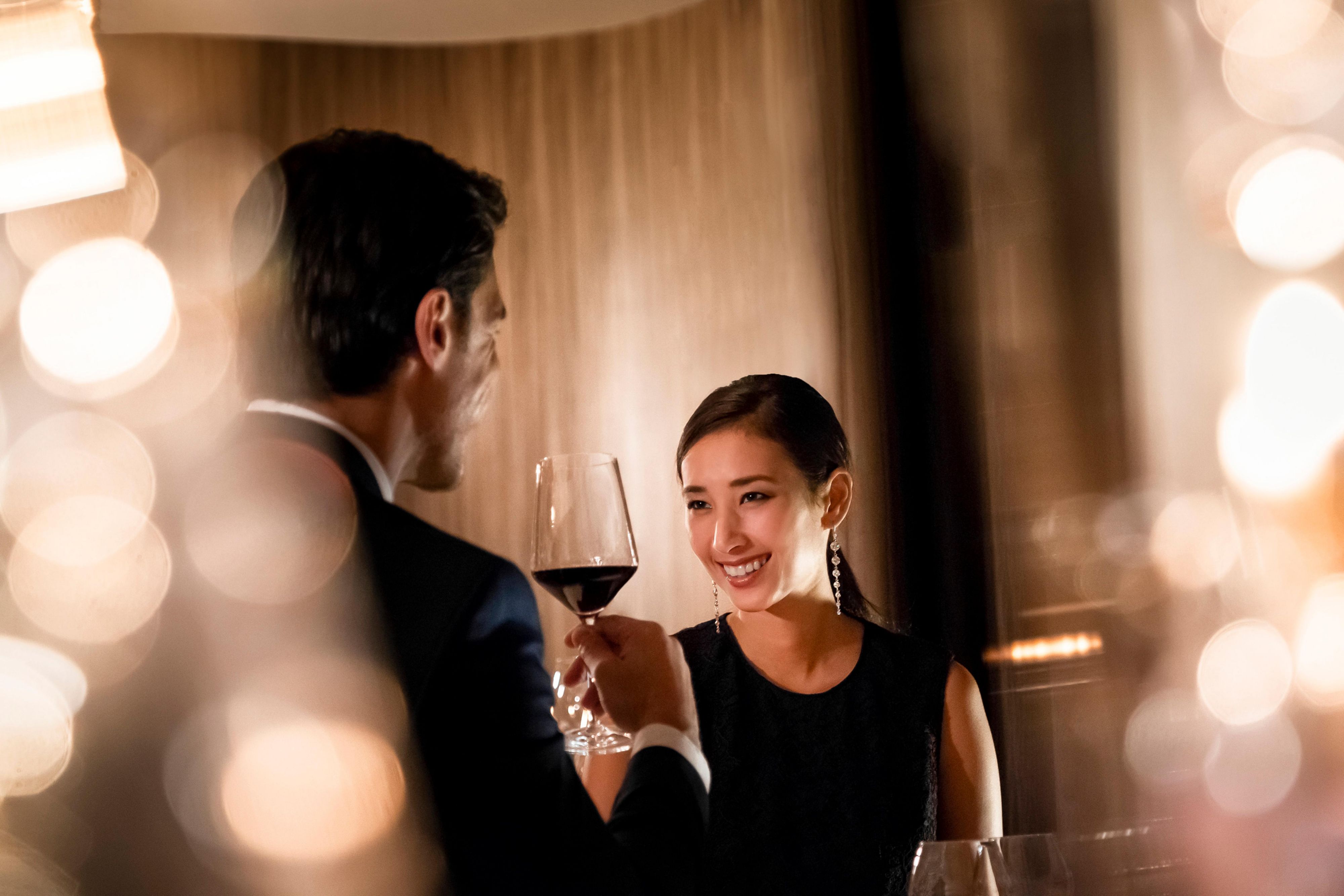 Couple enjoying wine and conversation in an elegant restaurant setting