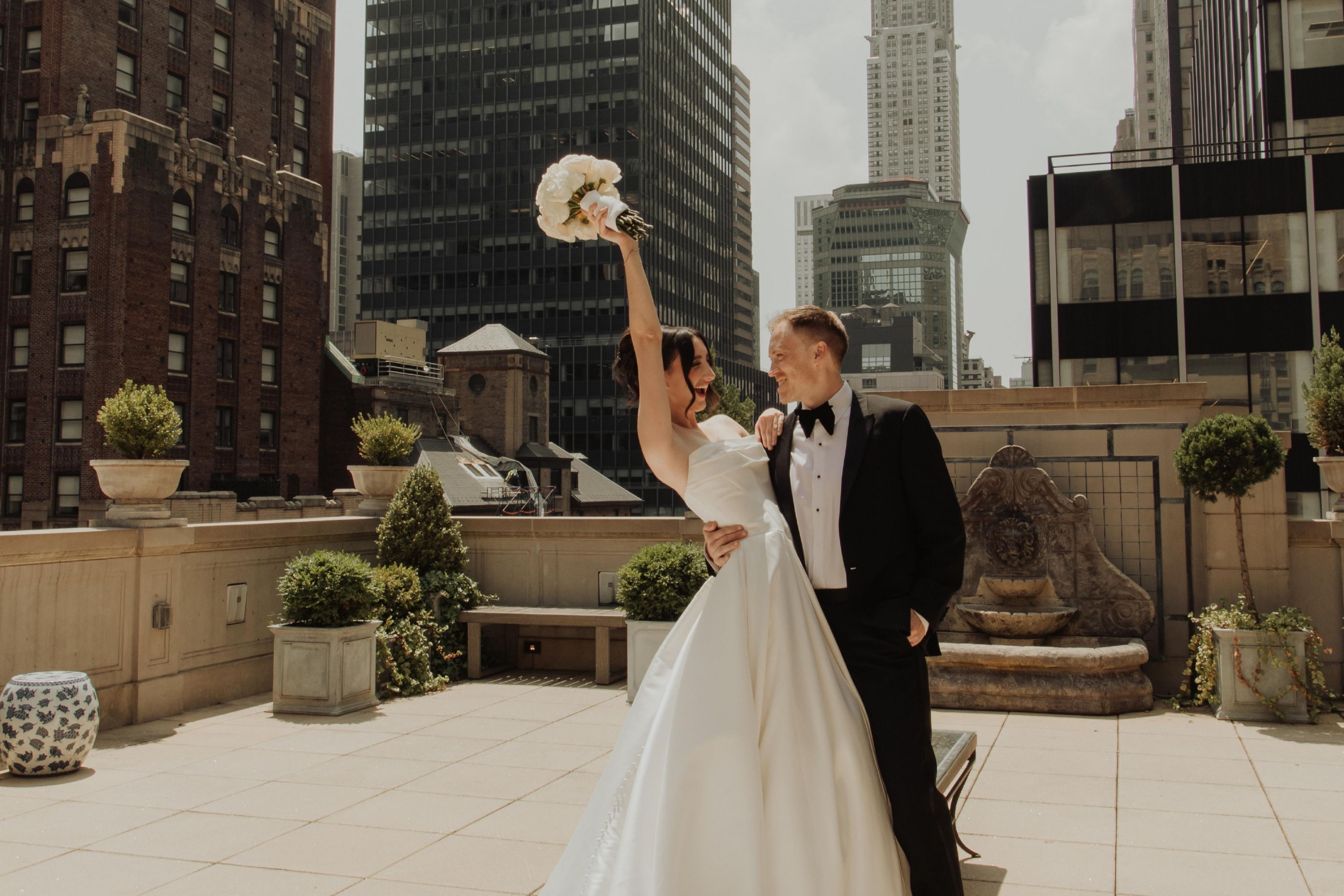 Bride and groom celebrating on the rooftop.