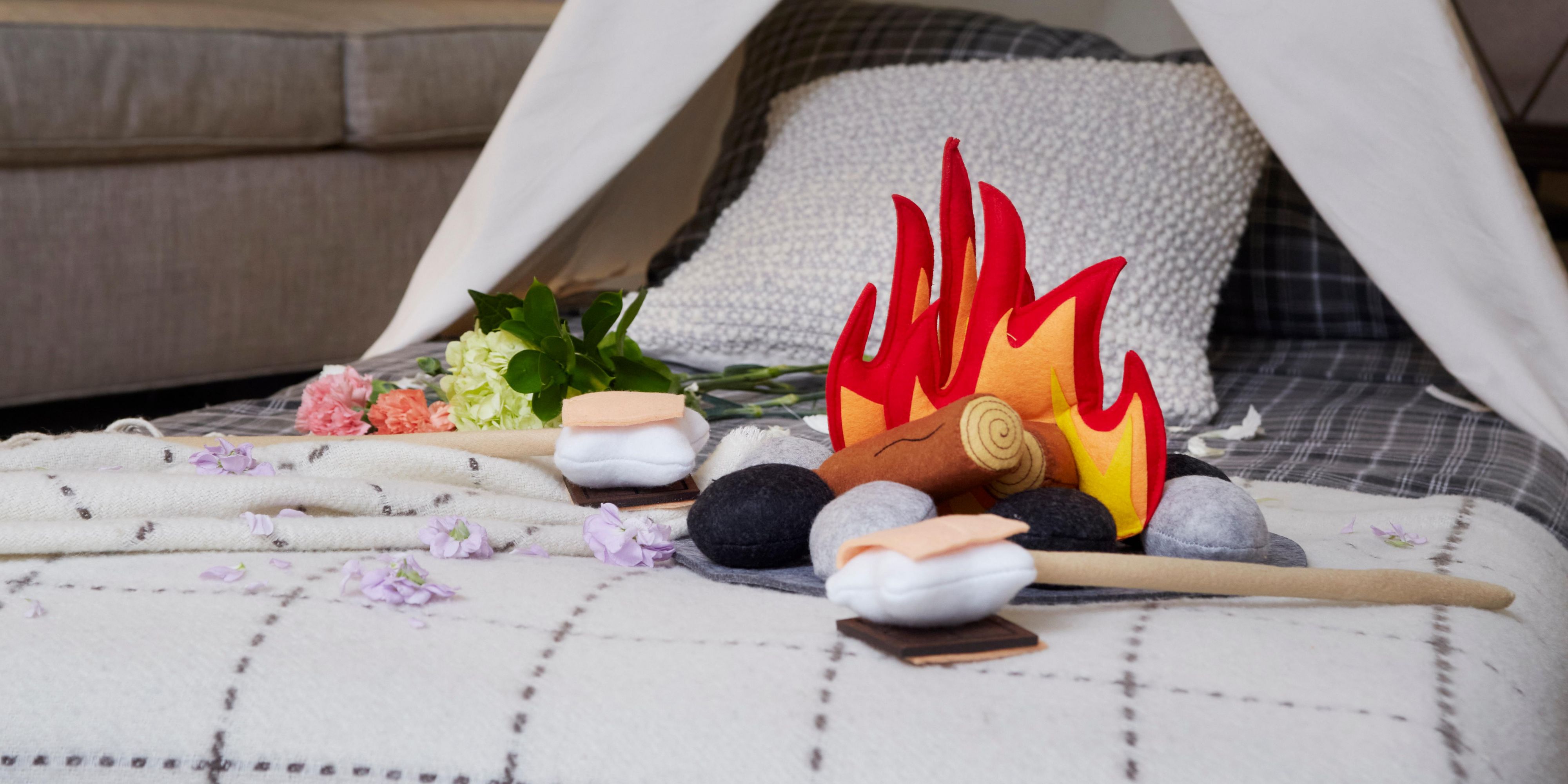 campfire shaped pillows on bed