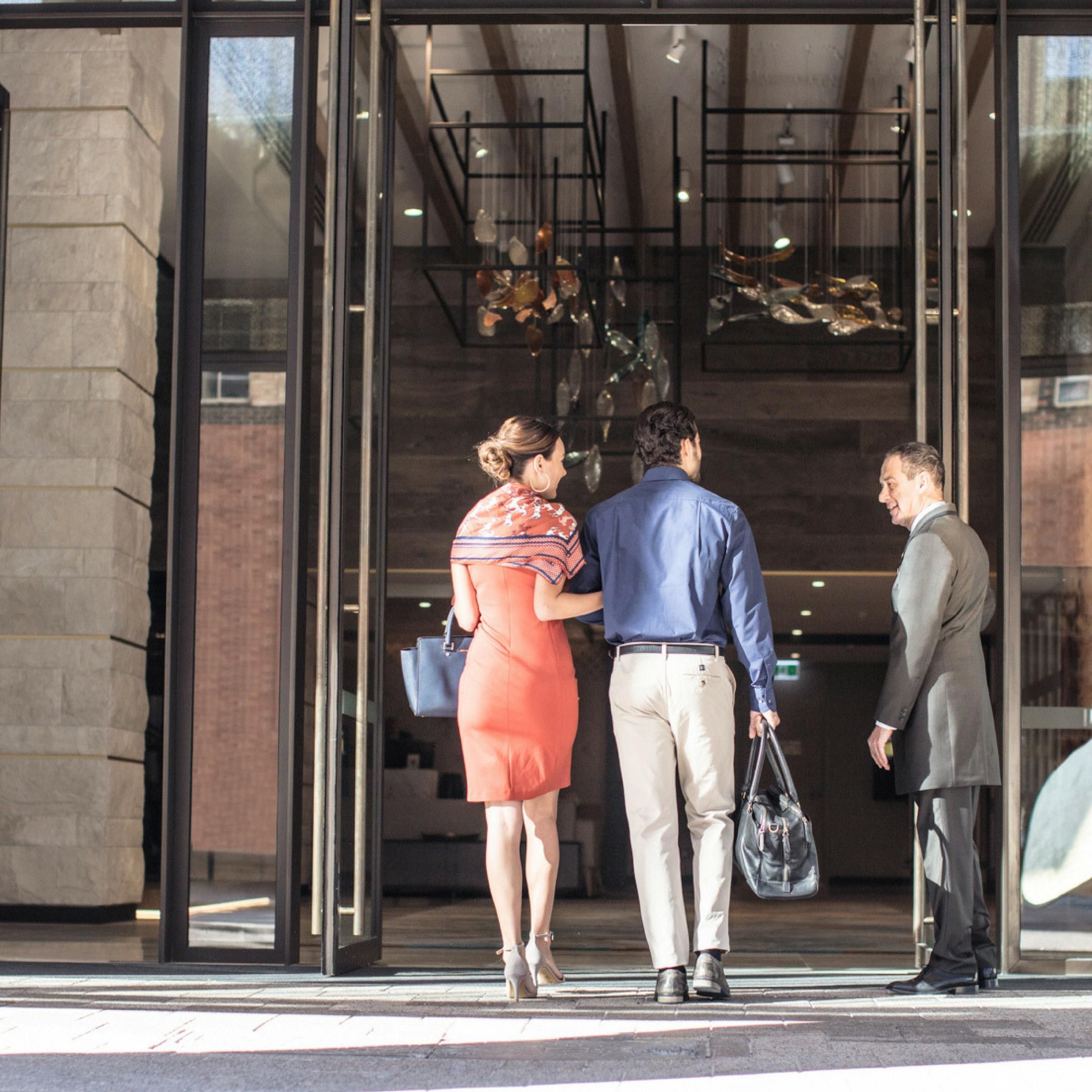 couple walking into the hotel