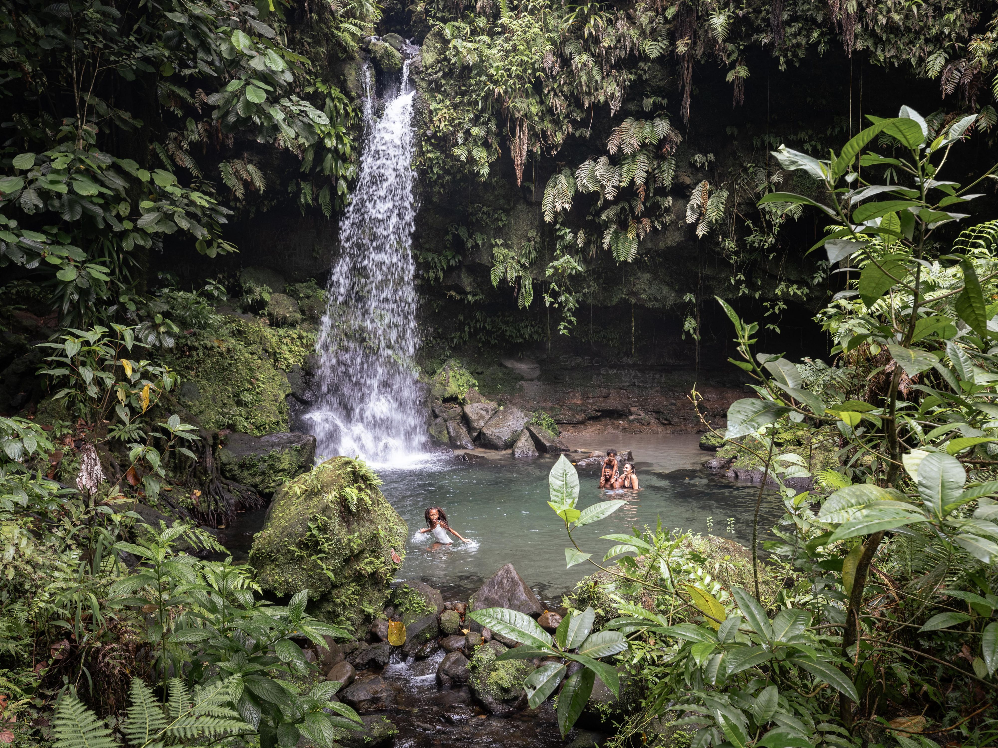 A beautiful waterfall with people swimming