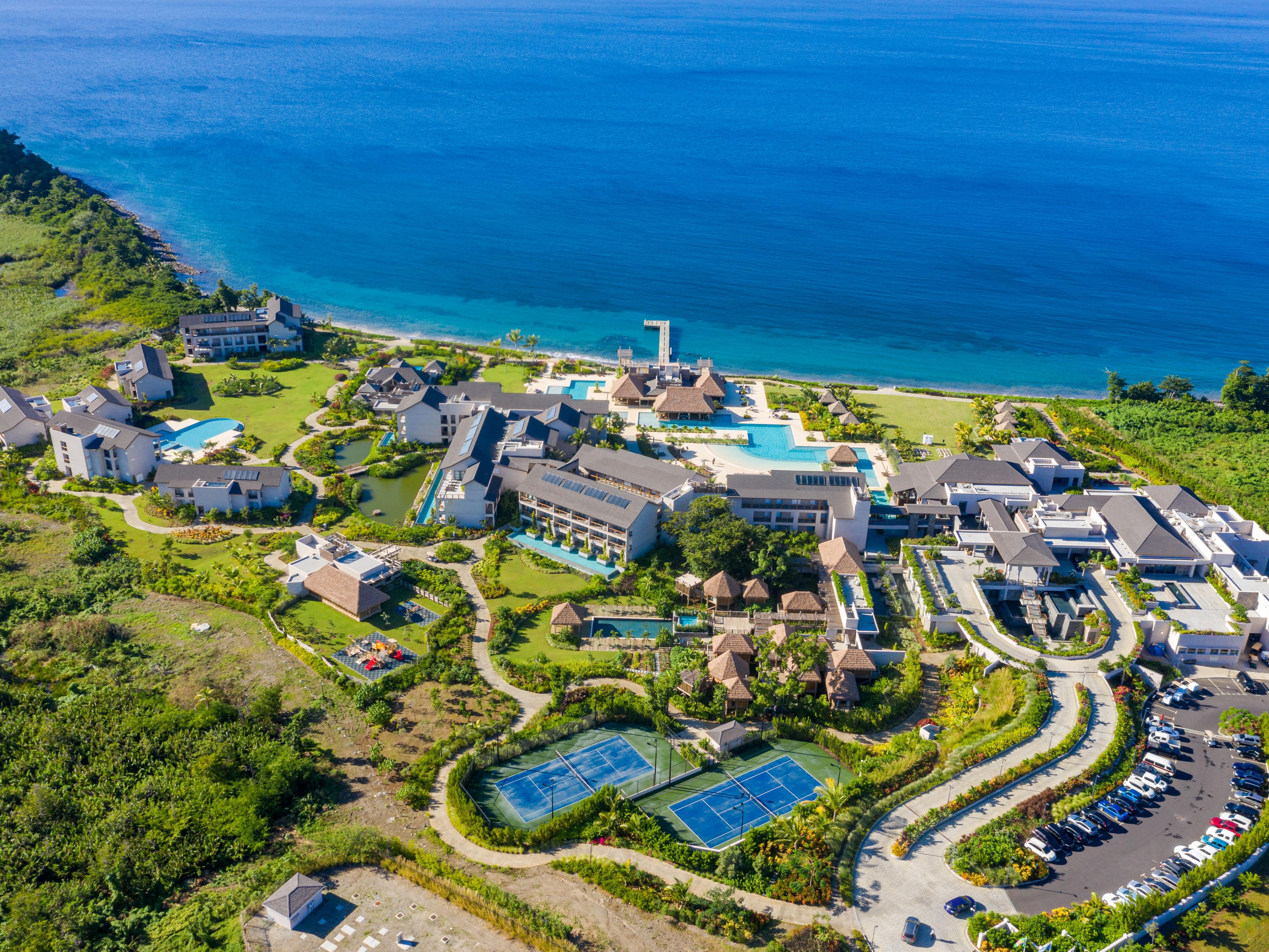 Aerial photo of hotel property that is adjacent to the ocean