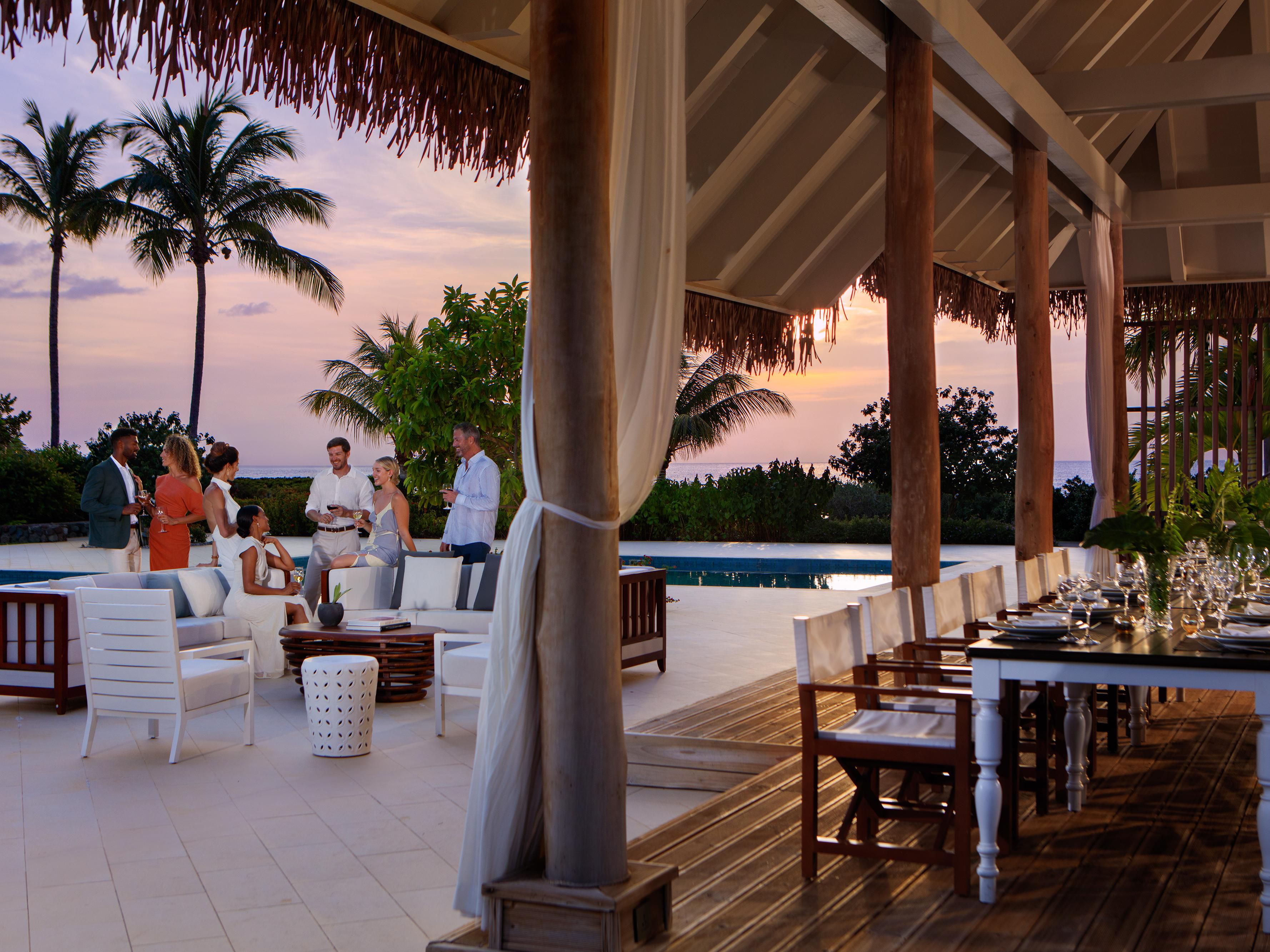 Group enjoying outdoor event by the pool.