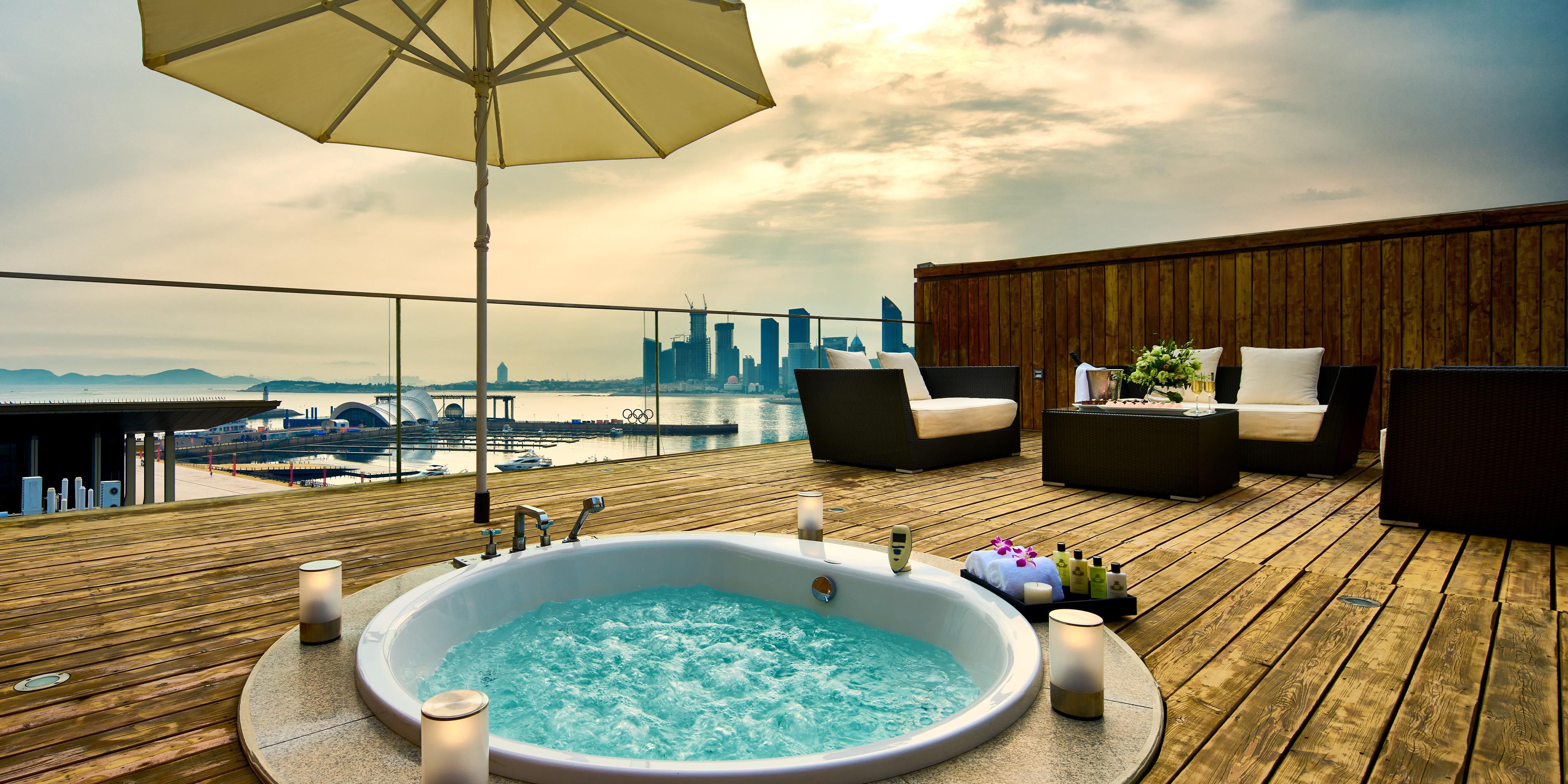 The sea breeze gently caresses along the vibrant Olympic Sailing Center, where sail shadows dance gracefully.  As night falls, on the open-air balcony, the warm mist from the jetted tub lingers, while the seascape light show is dazzlingly charming.