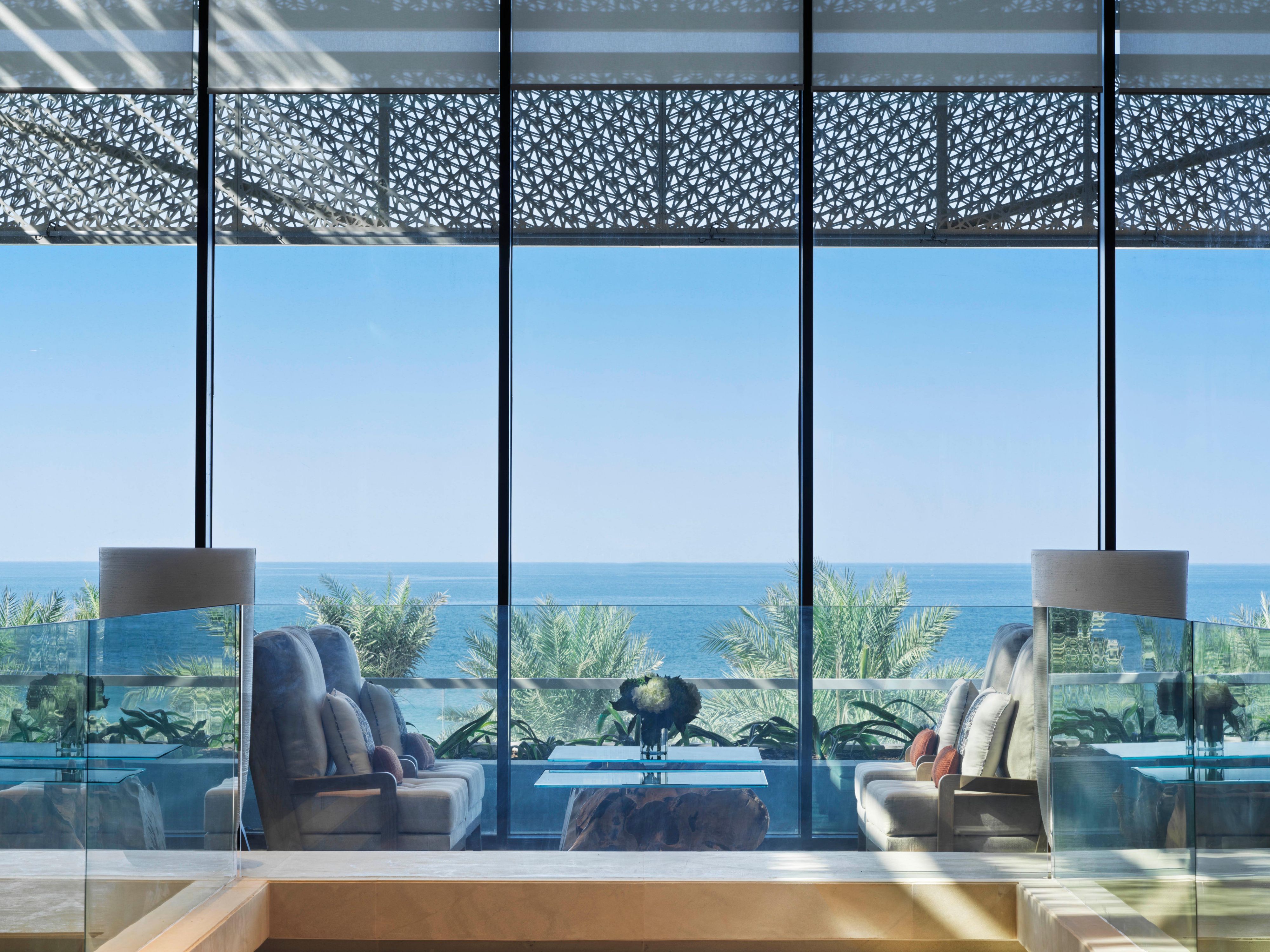 Get comfortable in the chair enjoying sea view in the lobby lounge