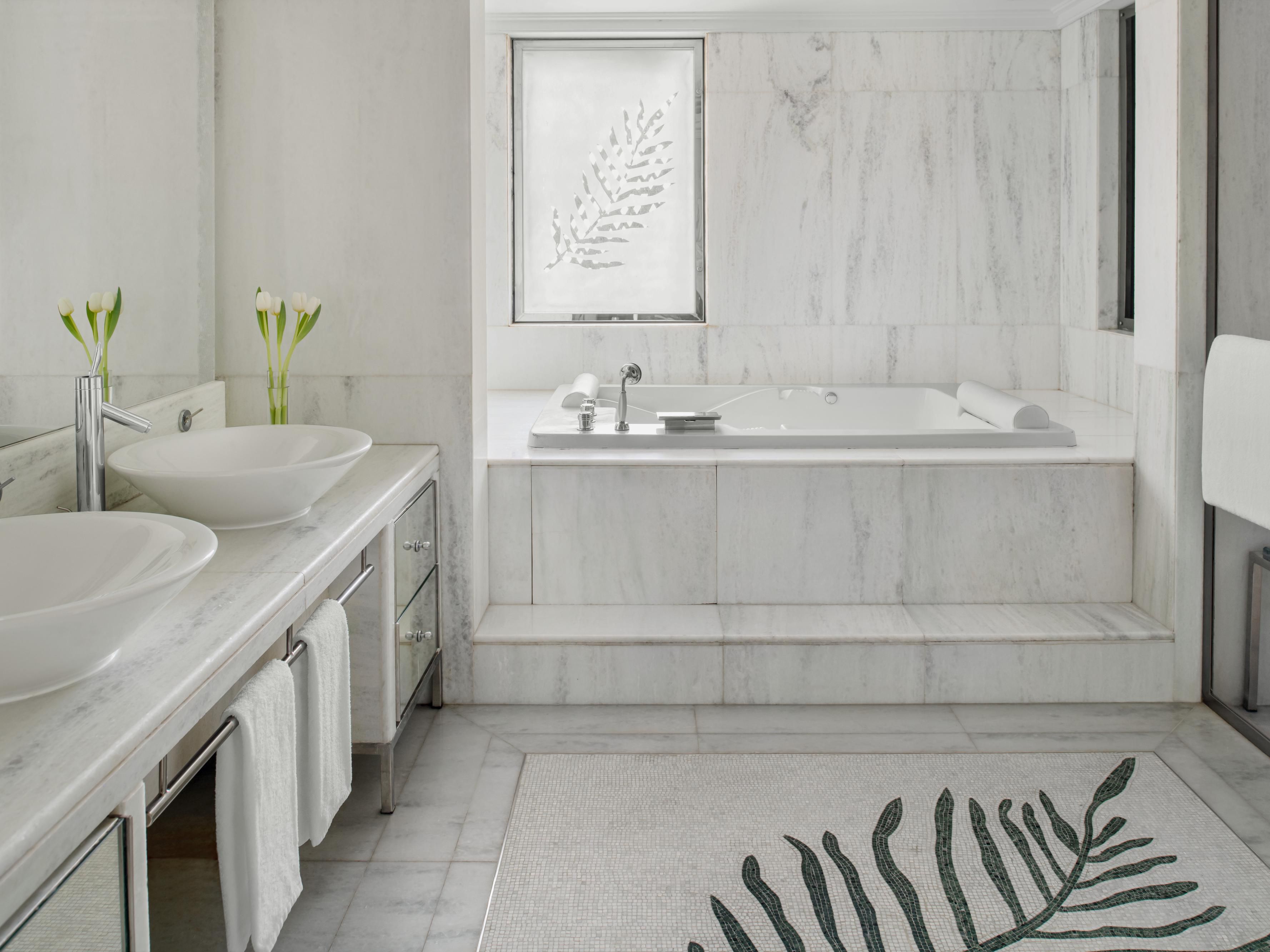 Enjoy an extravagant bath experience with marble accents