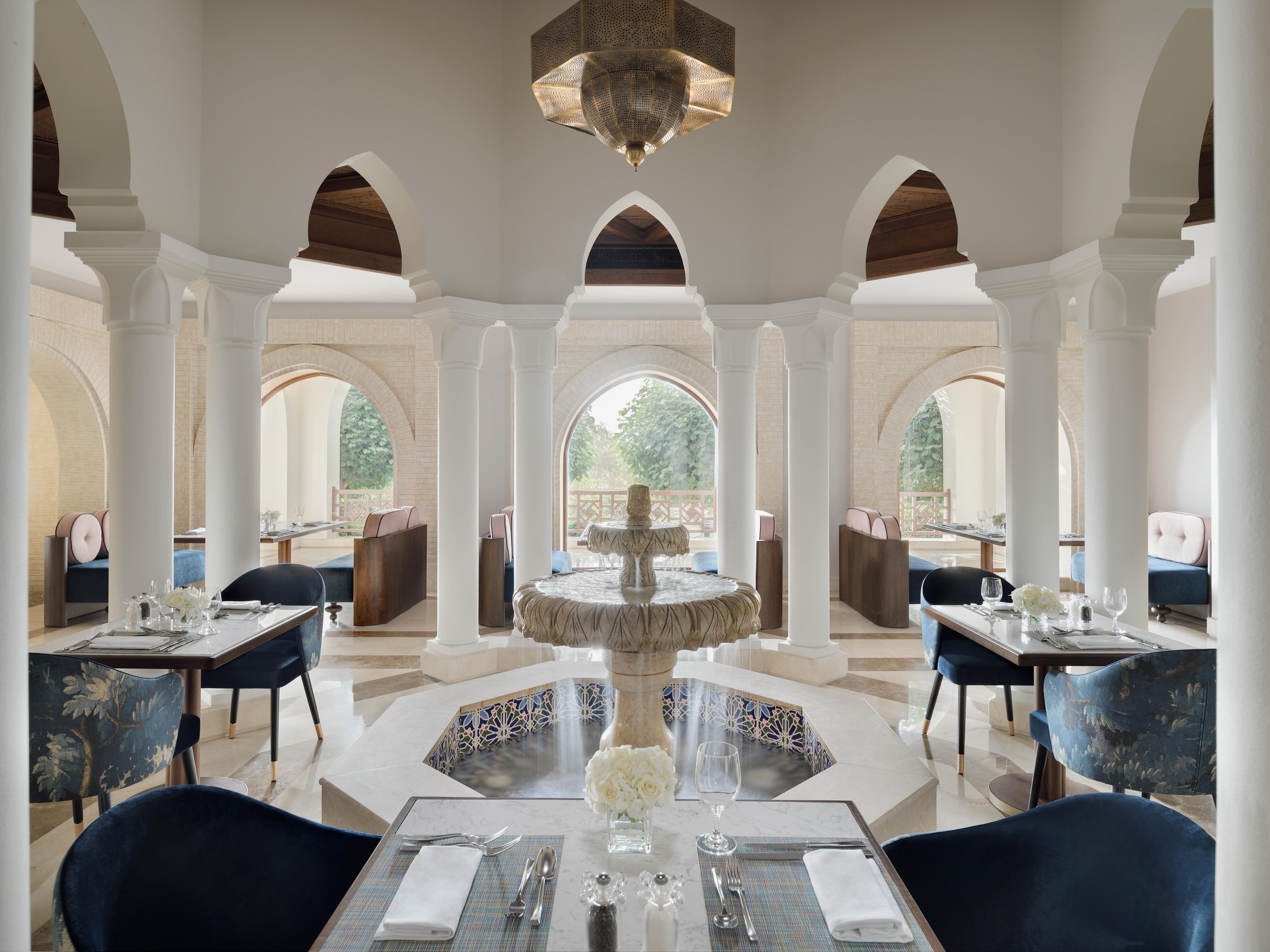 Enjoy the indoor foutain waters while having lunch at Les Palmiers
