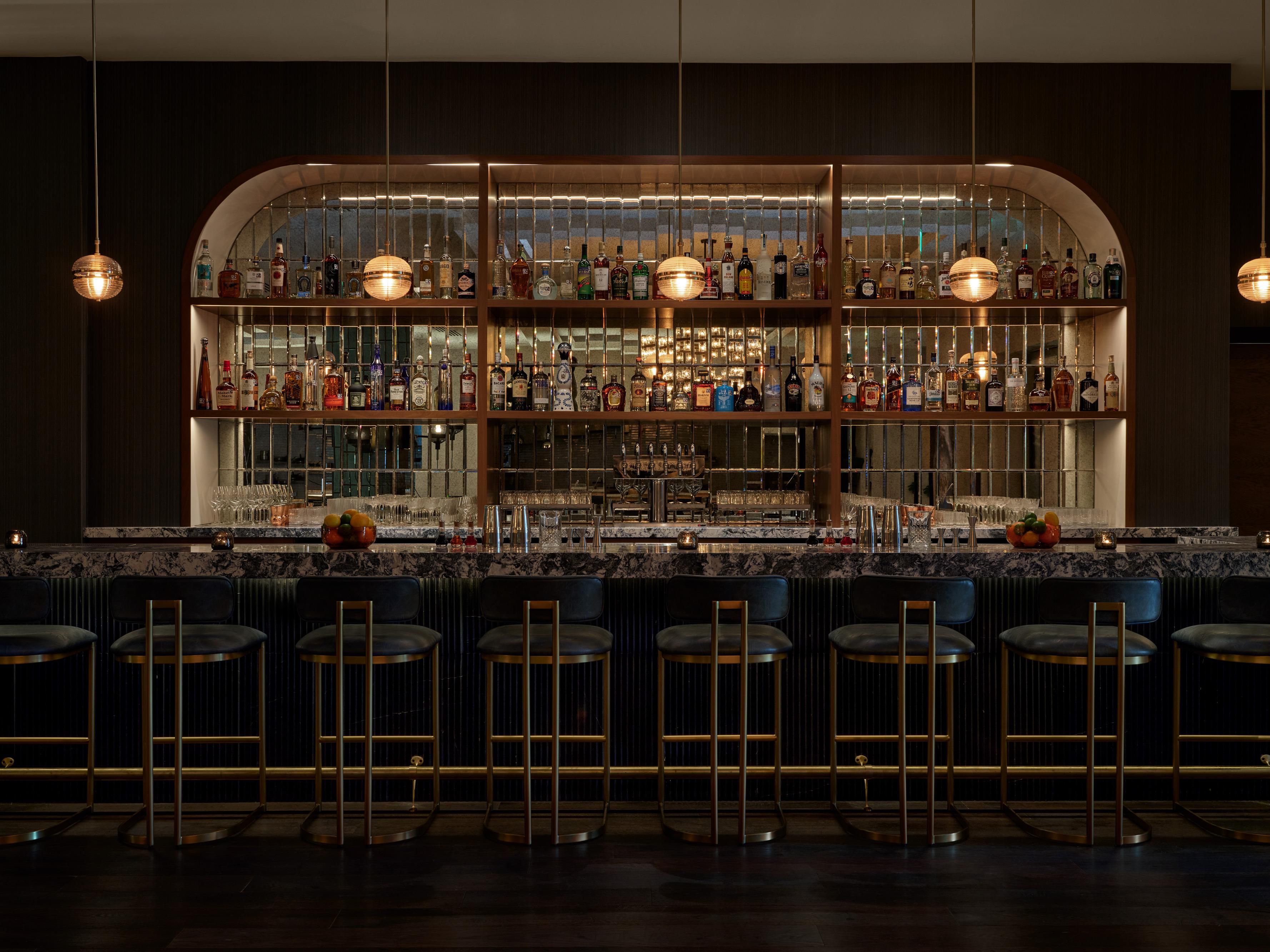 Restaurant's intimate bar seating invites sophisticated.