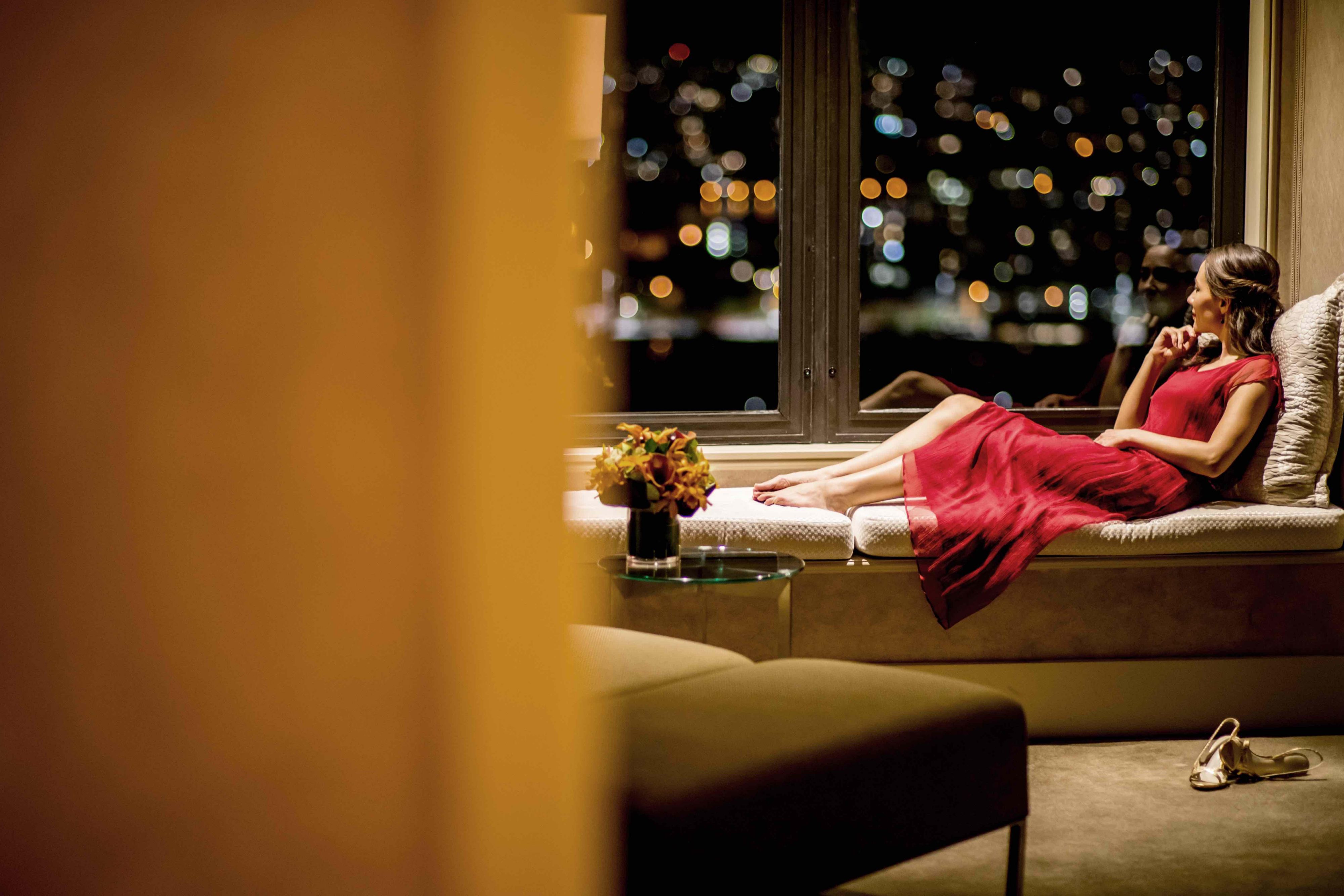 Woman sitting on chaise seat