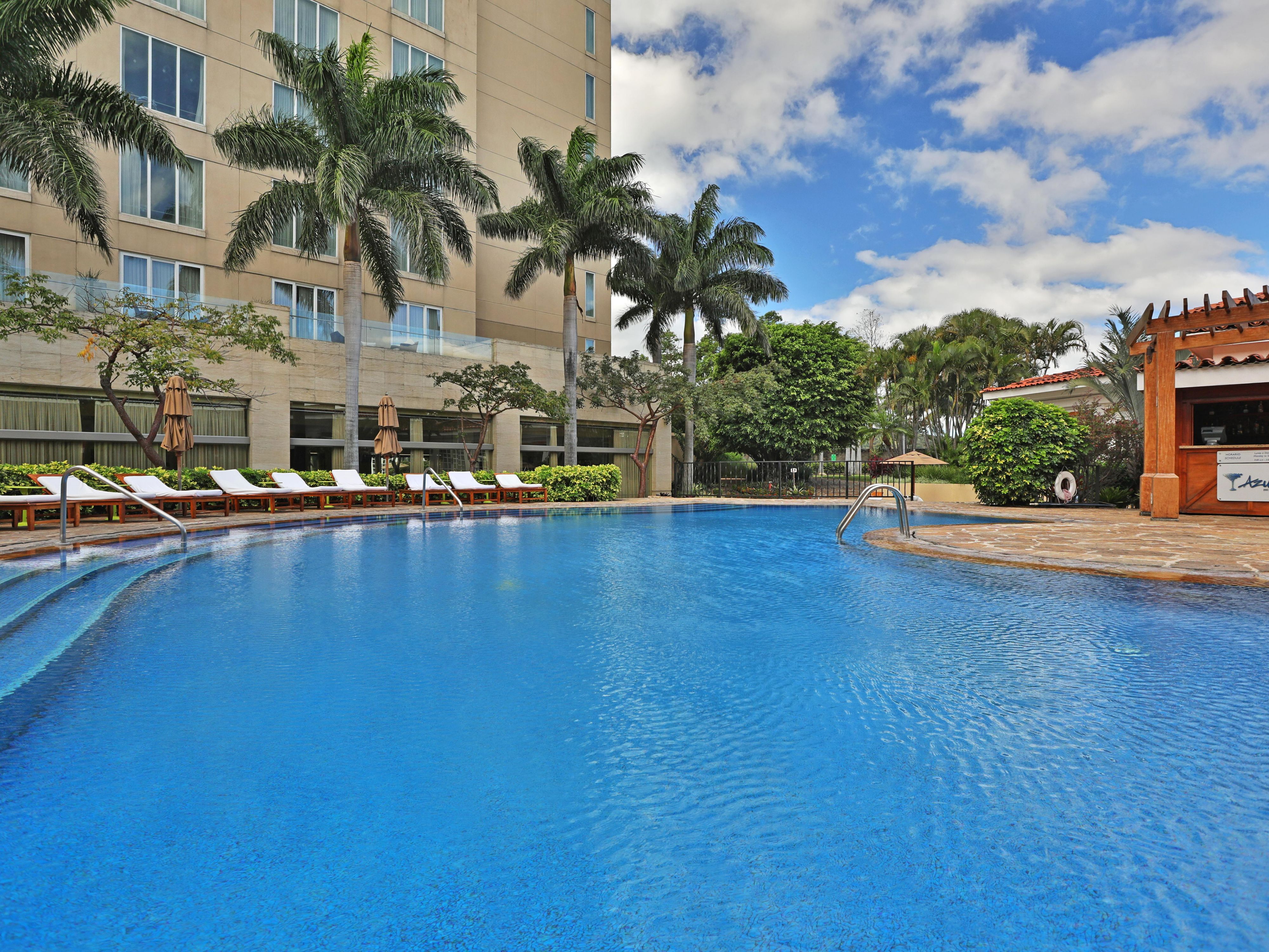 Take a morning dip in our outdoor pool under the blue skies.
