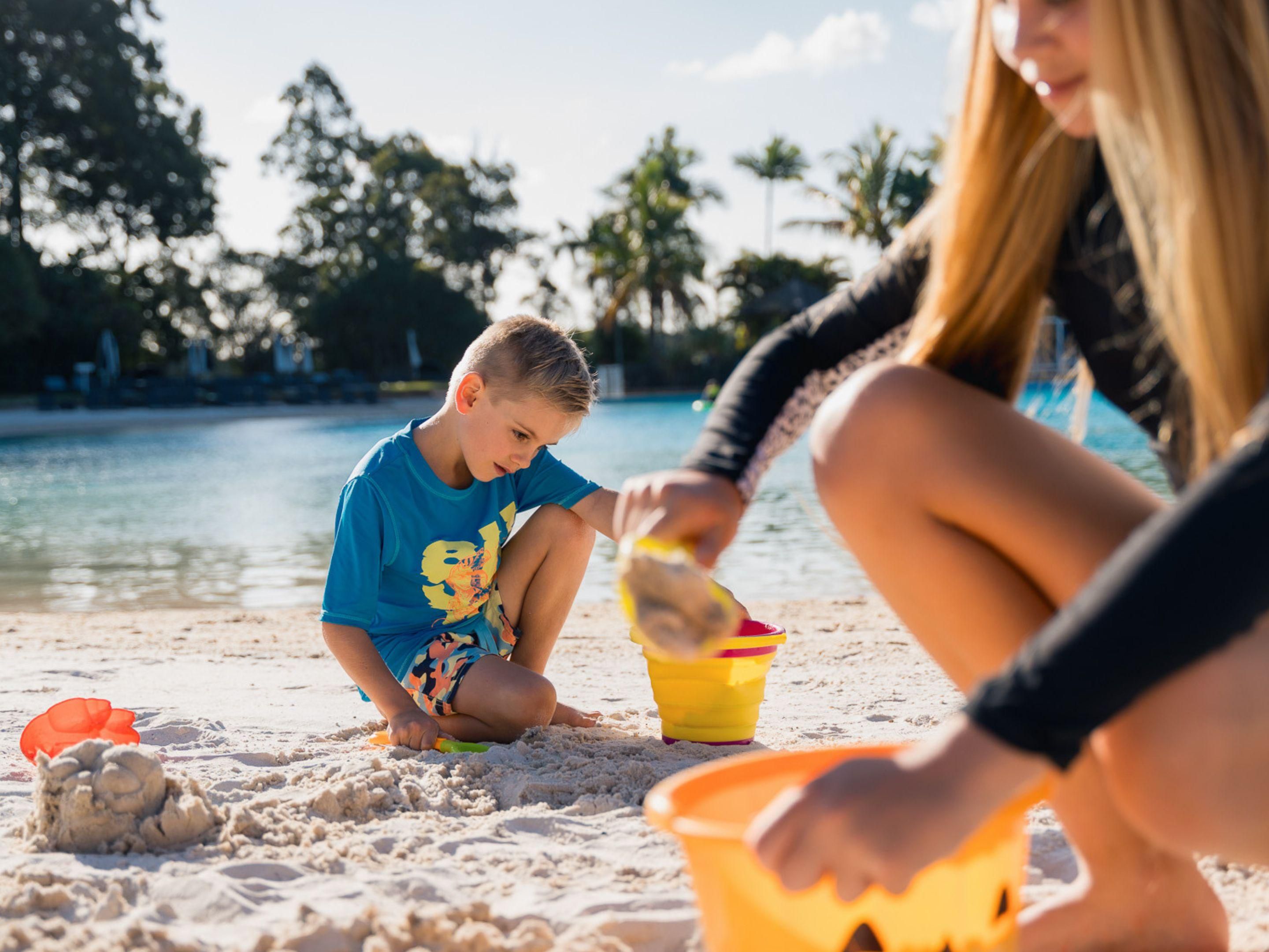 Children playing in the sand on the lagoon beach