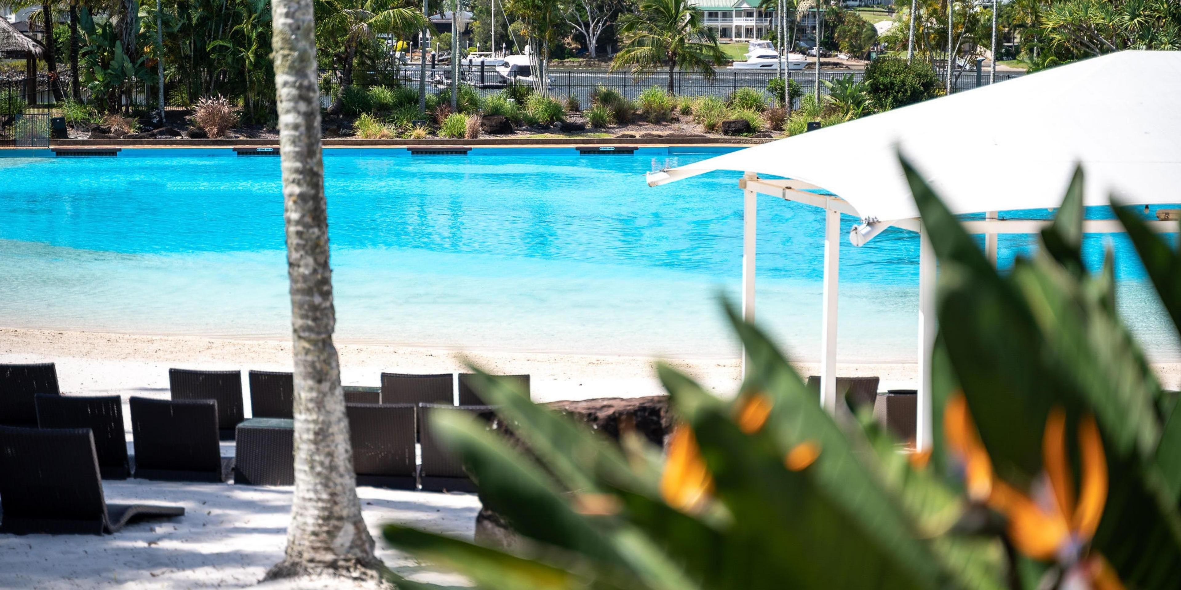 Experience the sea and the sand without stepping foot off the resort. Our saltwater Lagoon Beach, set within a subtropical garden lined with palm trees, expands over one acre. Nearby, the Coomera River serves as a natural backdrop to the pristine blue hues of the lagoon's crystal-like water. 