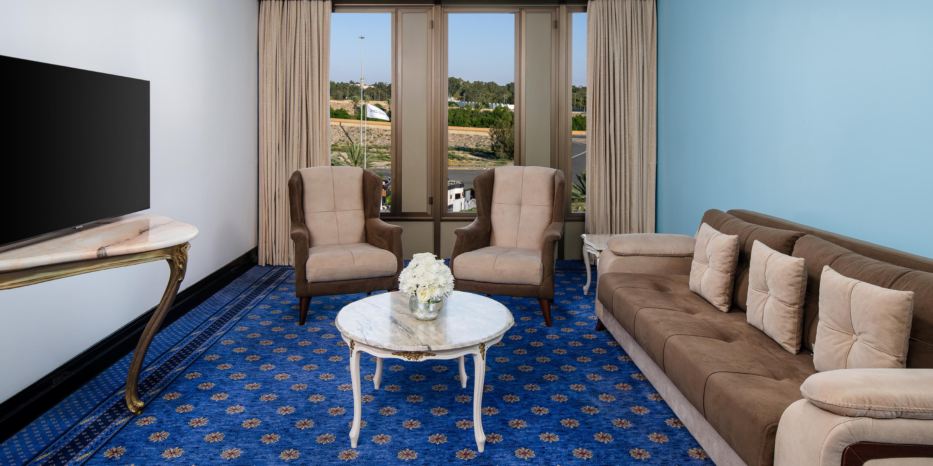 Relax in style in the spacious living room of the suite