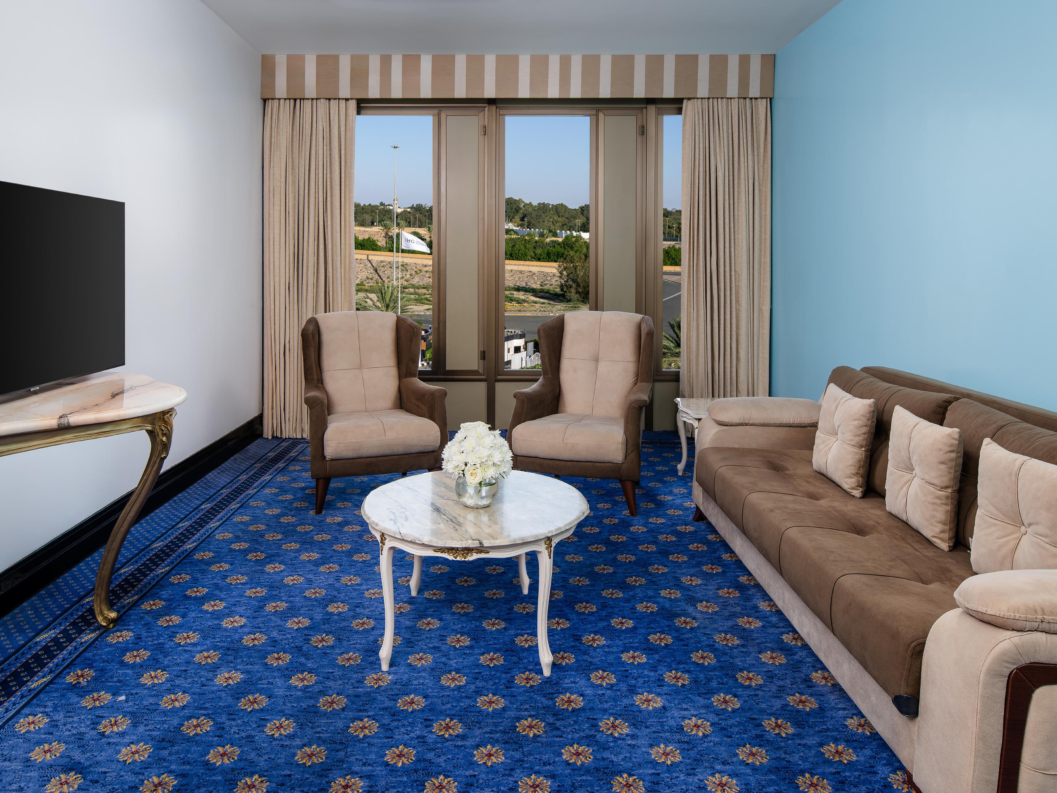 Relax in style in the spacious living room of the suite