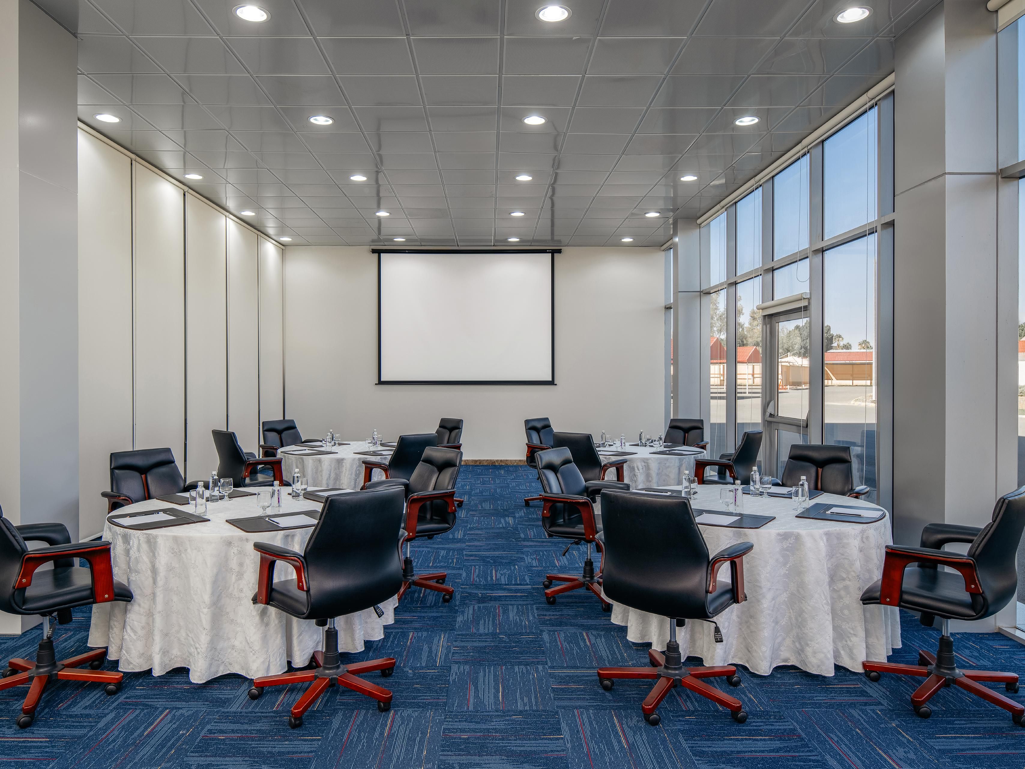 Host meetings in the classic Al Shafa room with natural light
