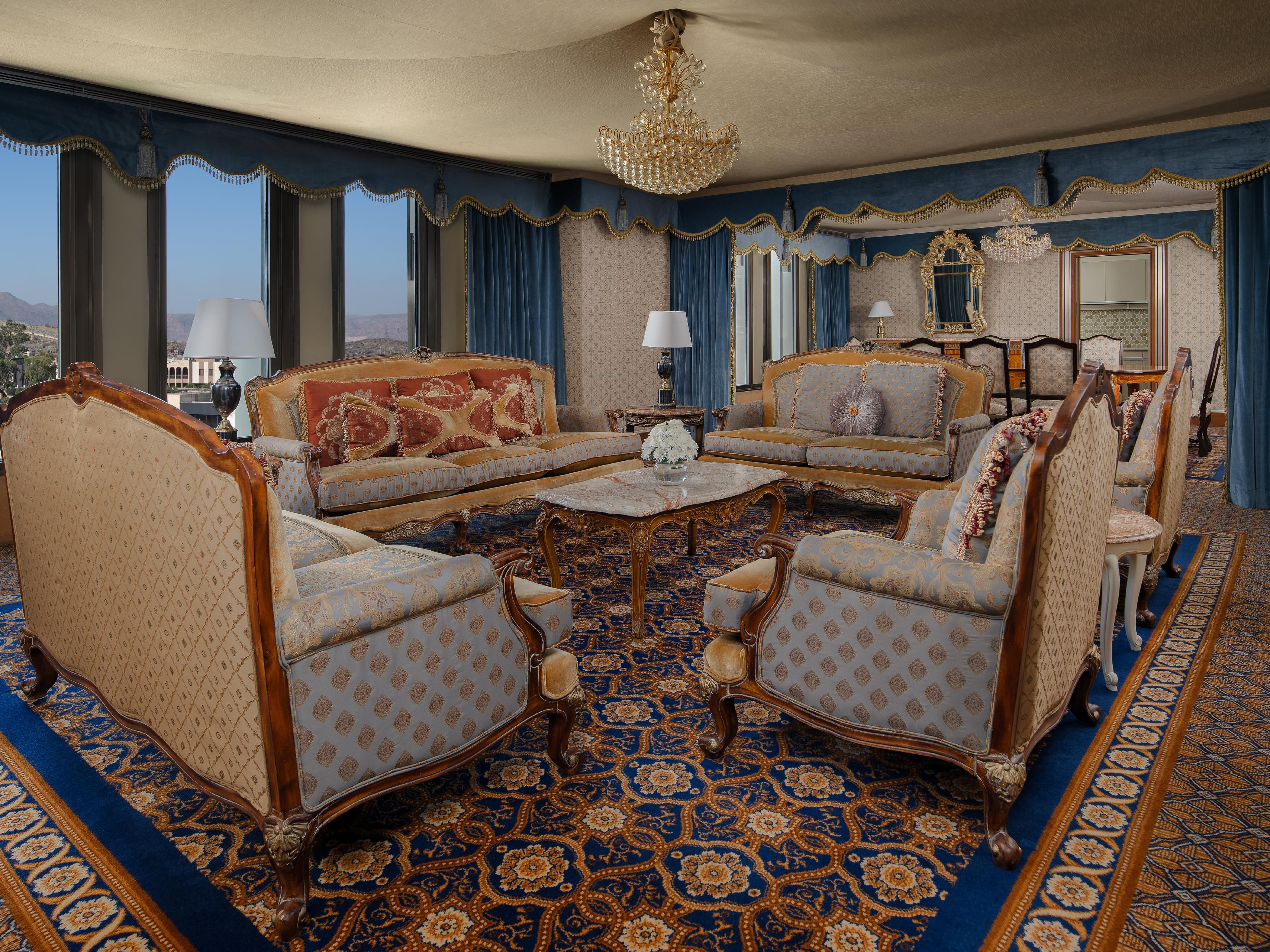 Relax in luxury in the spacious living area of the Royal Suite