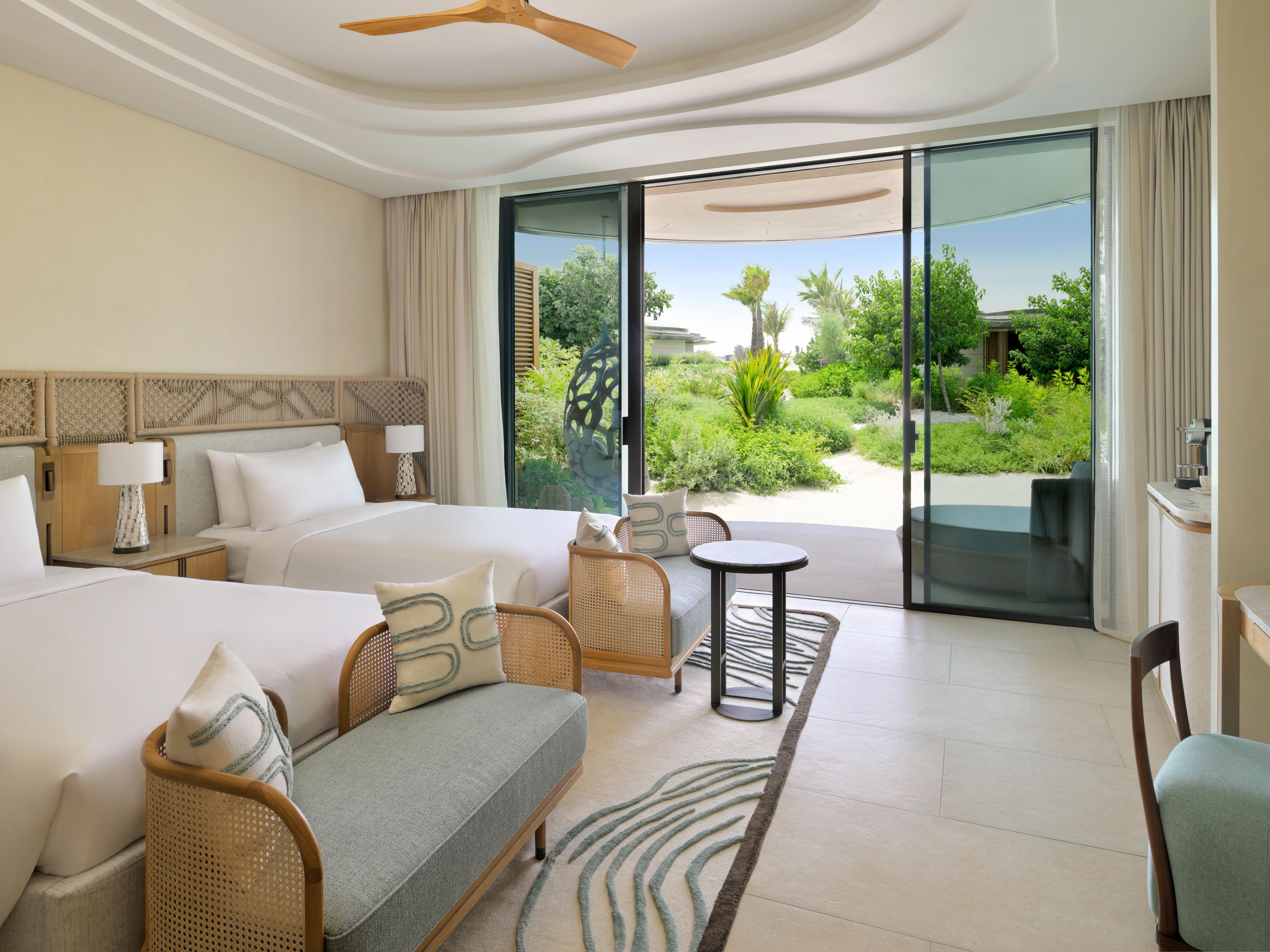 A serene twin room overlooking lush resort grounds