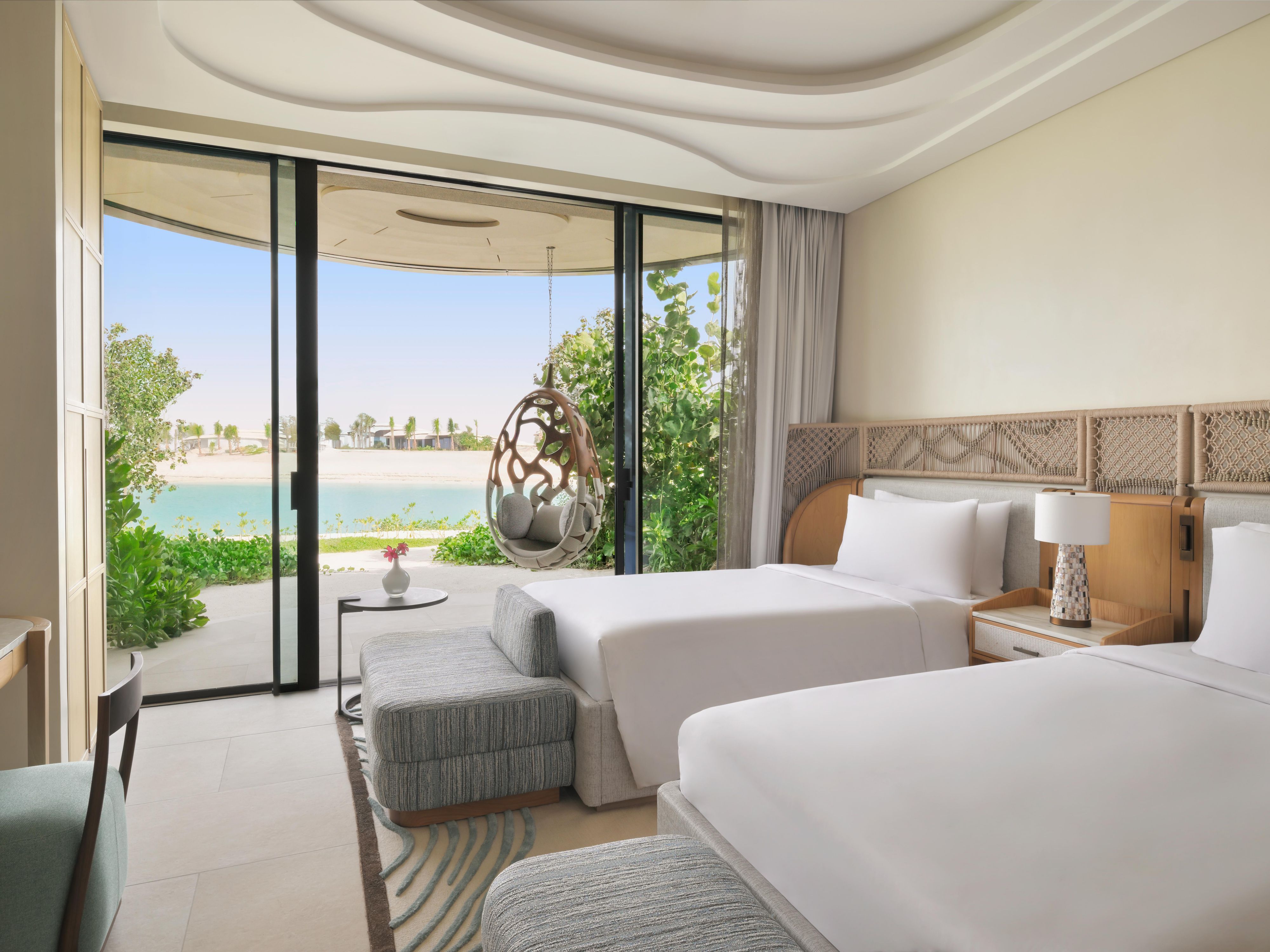 A restful twin bedroom with timeless beach and lagoon charm