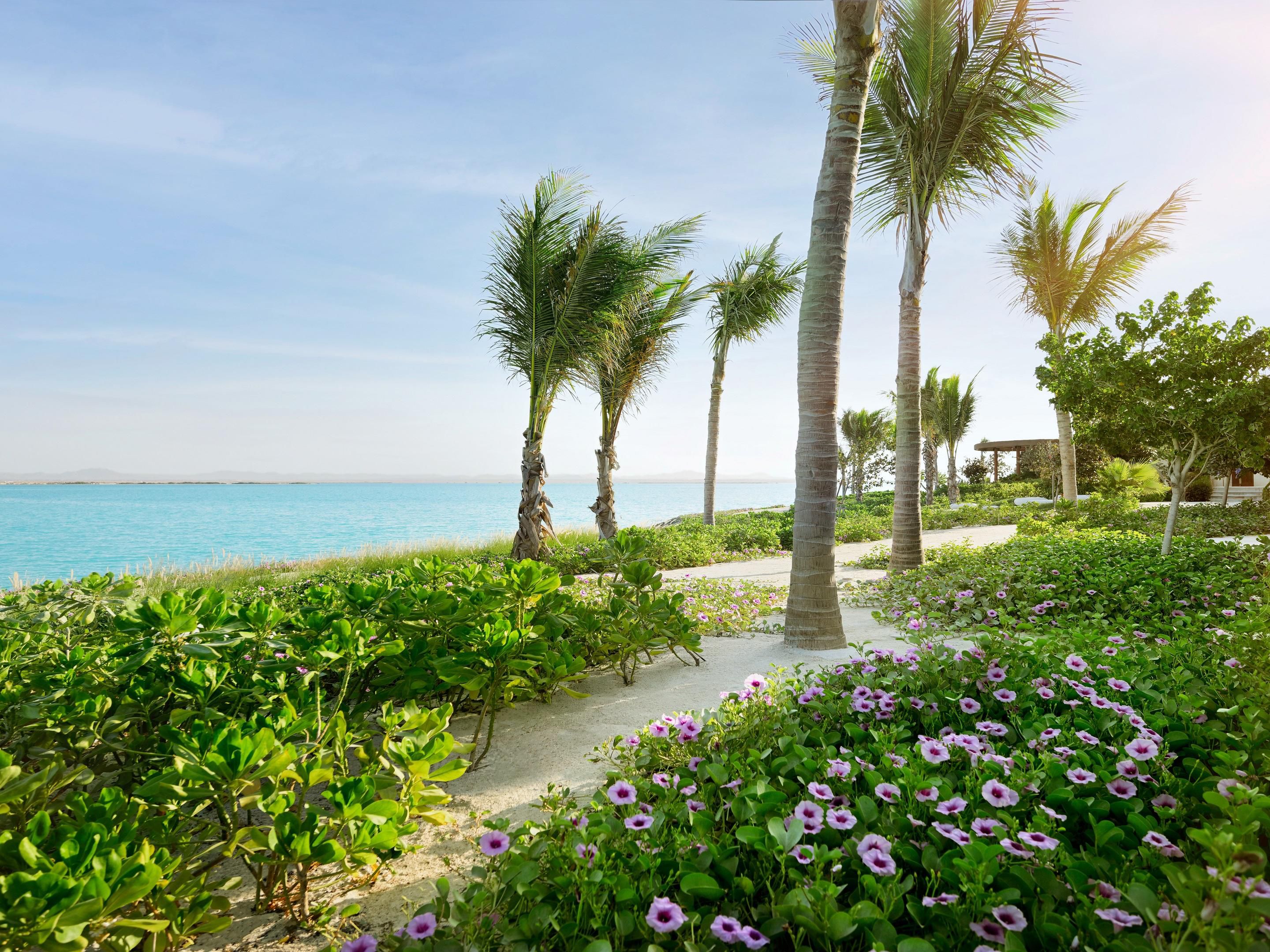 Soft sands, lush greenery and gentle waves invite timeless escape