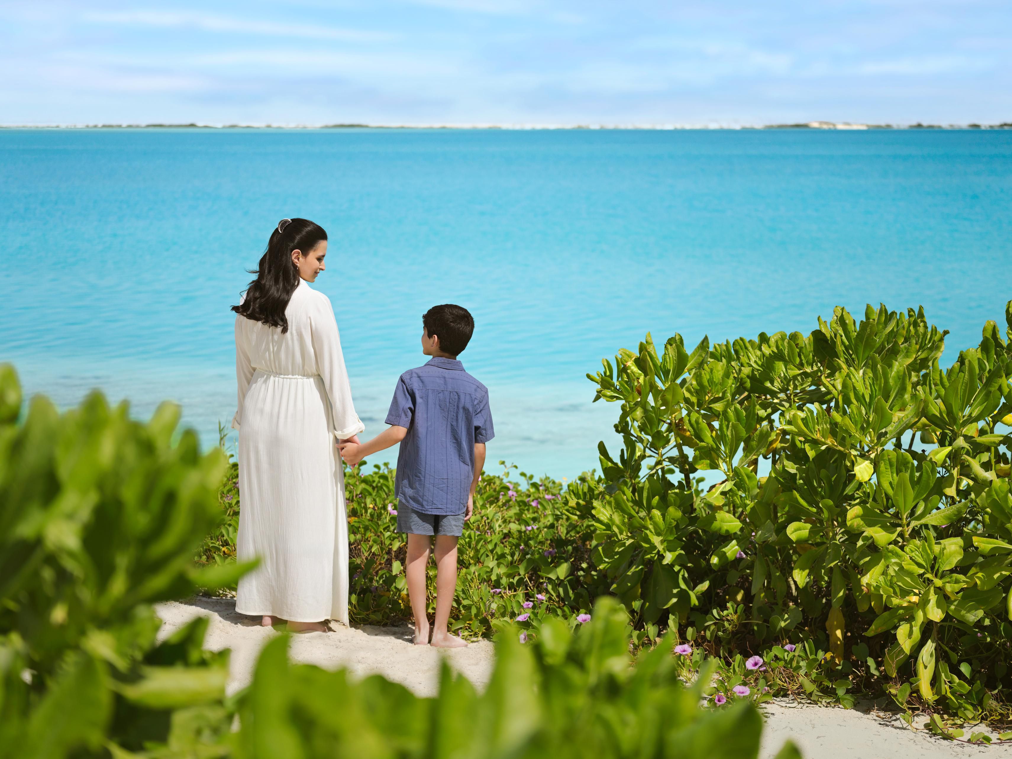 Endless blue sea framed by lush green