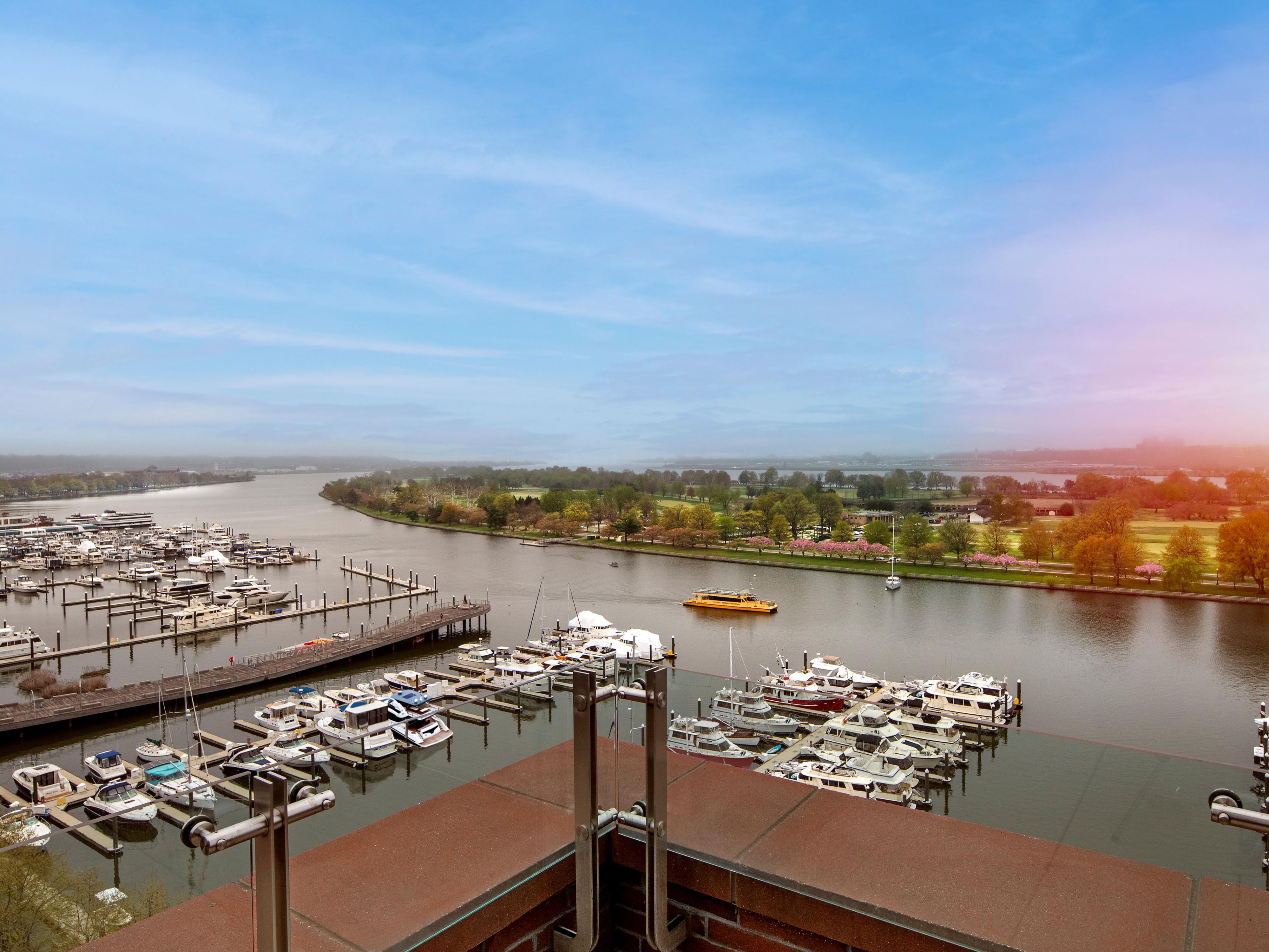 Elevated view of The Wharf marina and river at sunset.