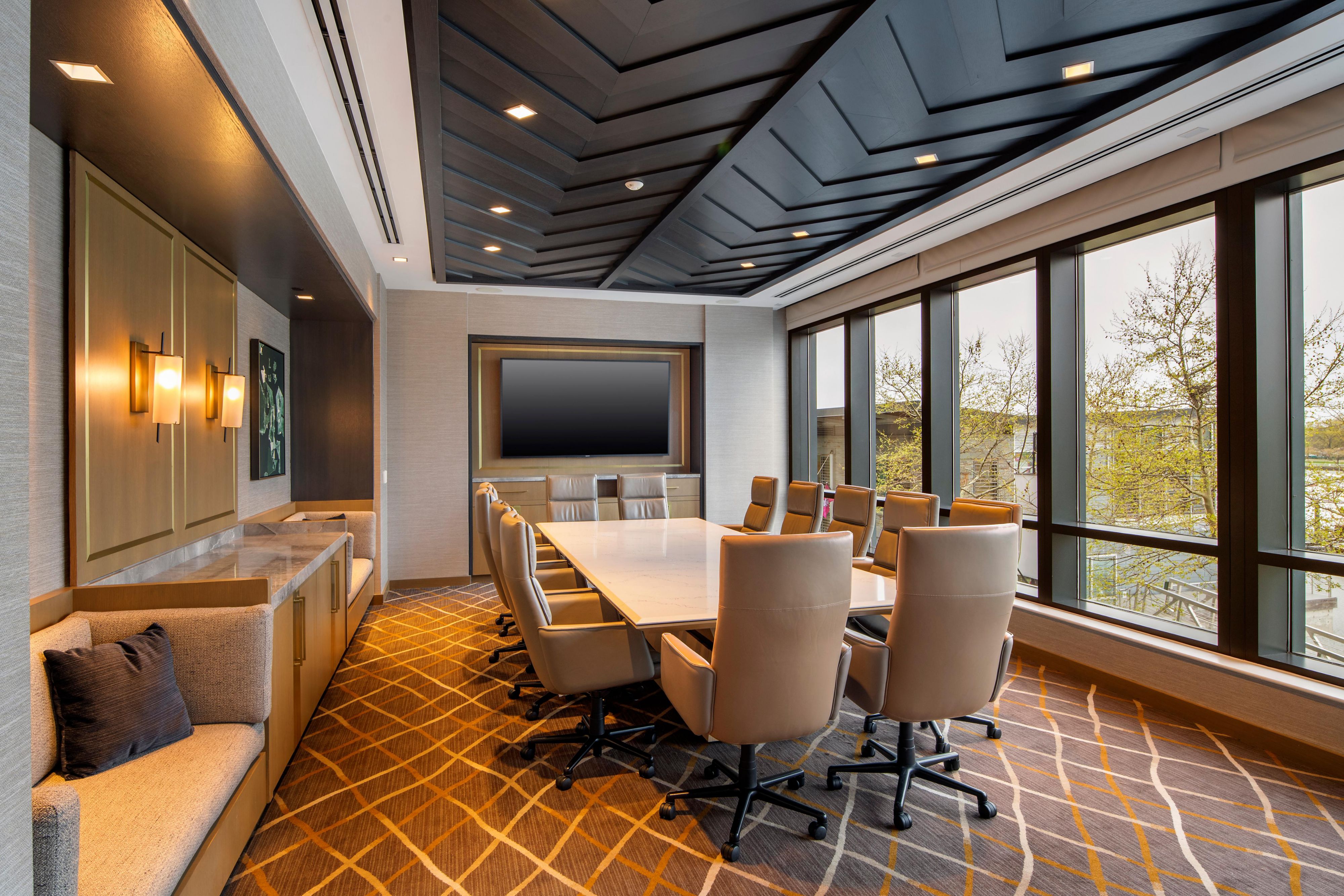 Refined boardroom with large table and natural light.