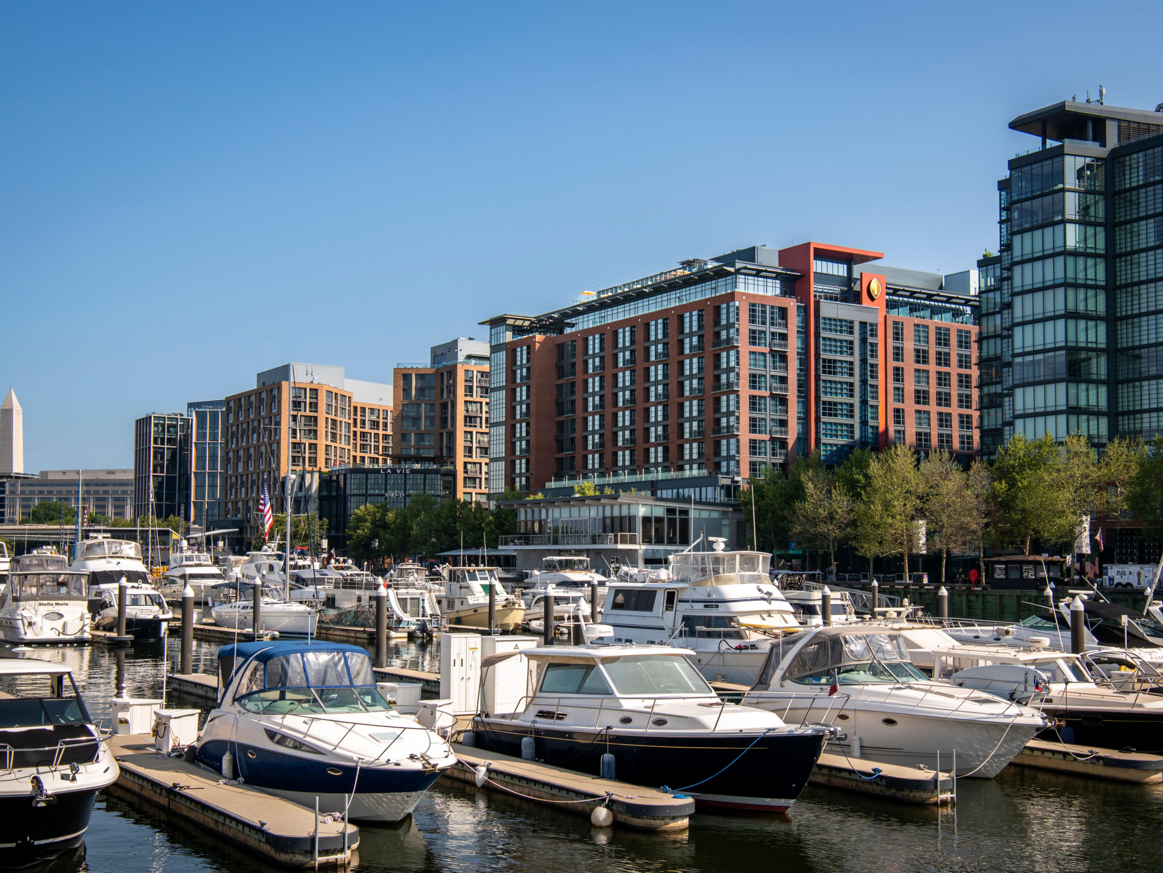 Wharf marina with docked boats and the Washington Monument.