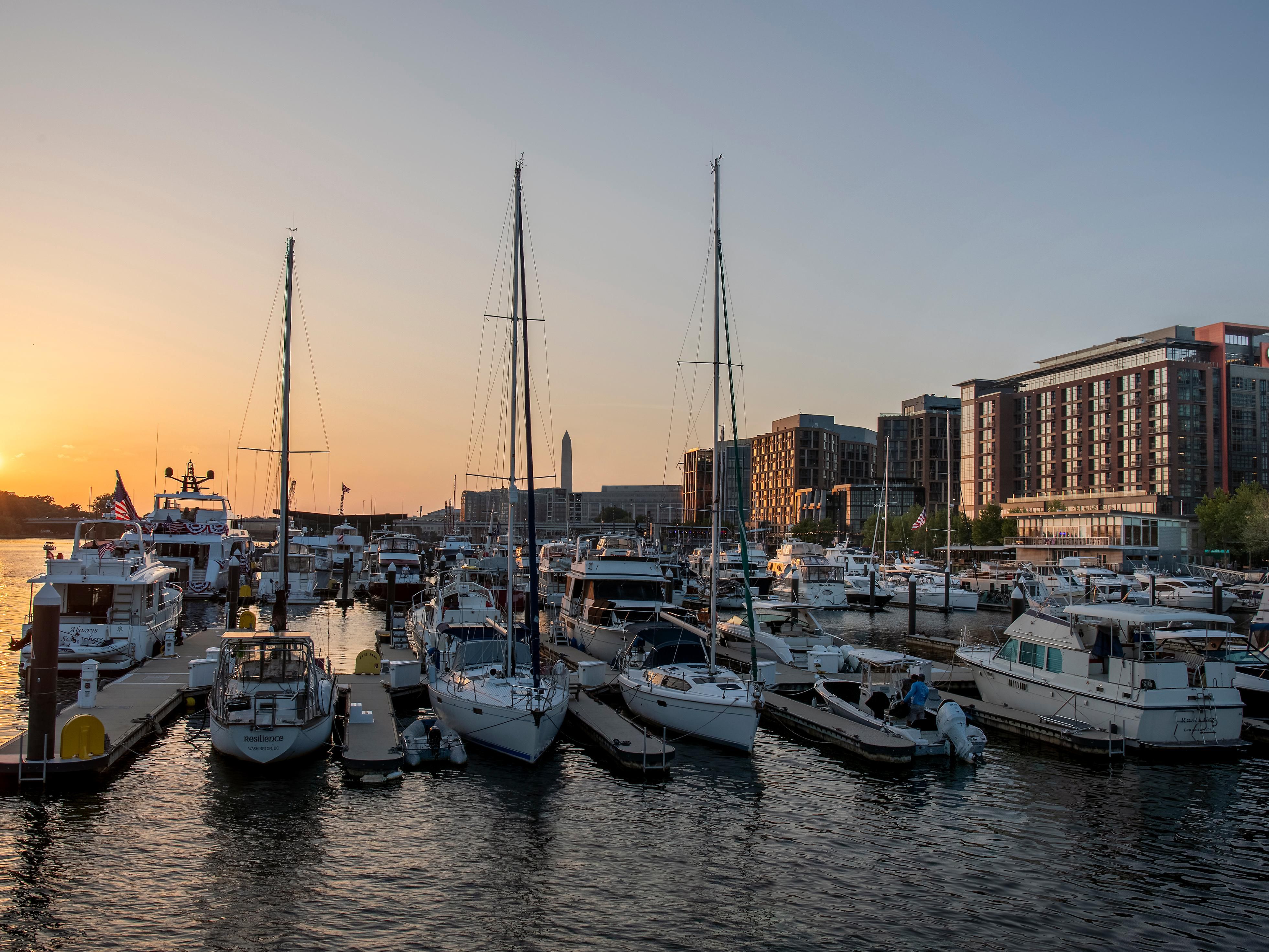 Golden hour over the Wharf marina with sailboats and monument.