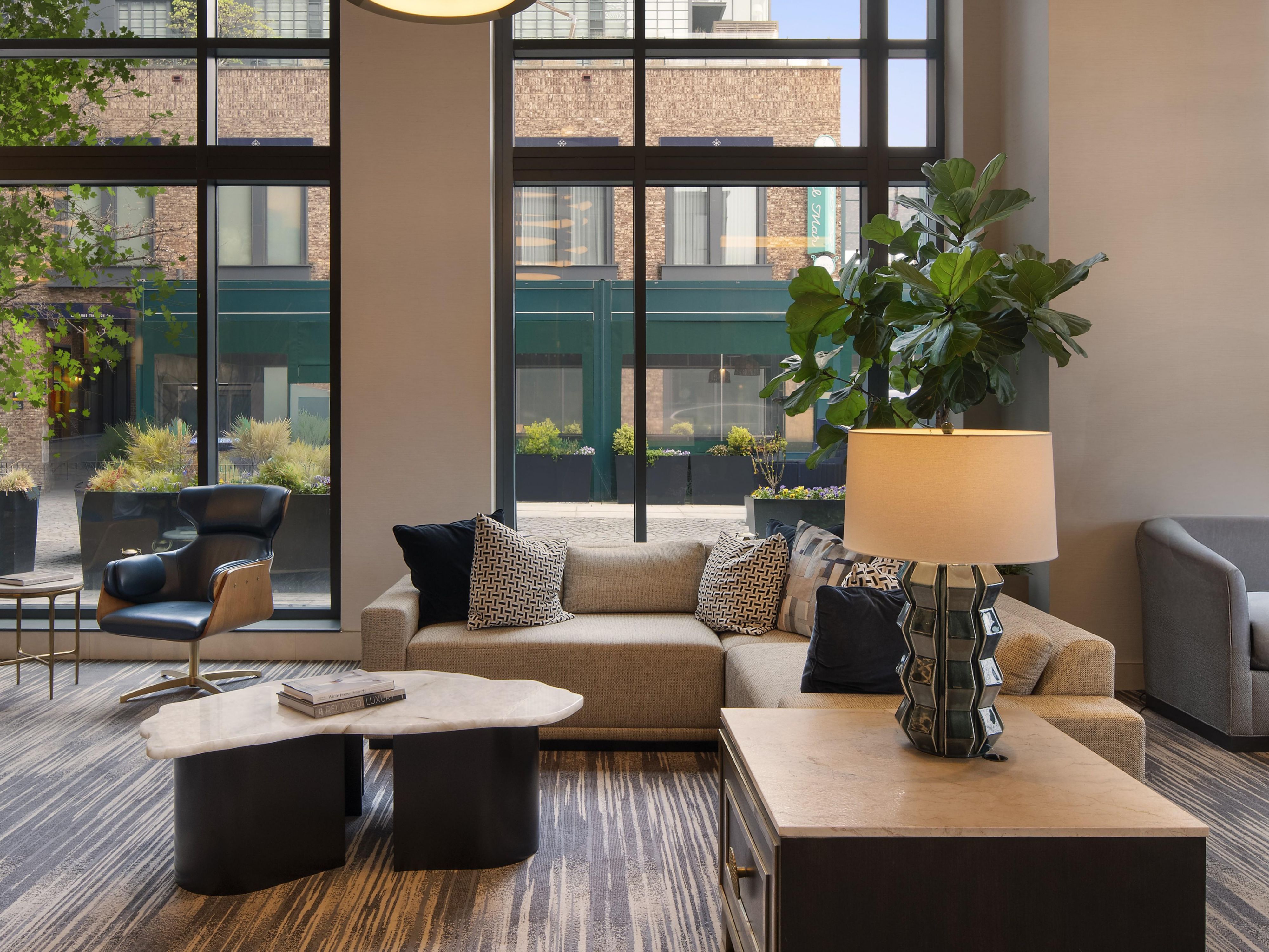 Modern lobby lounge with circular chandelier and city views