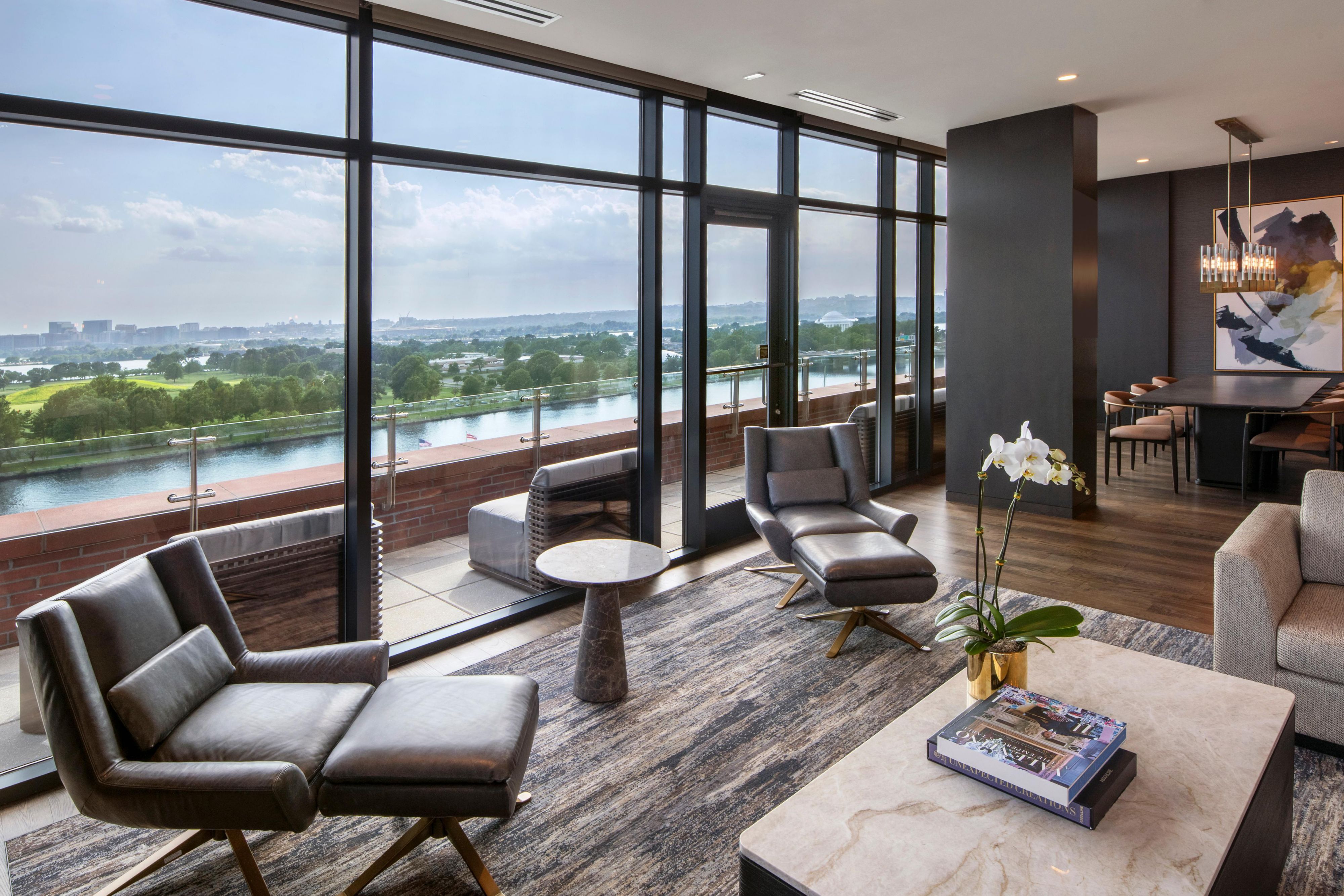 Grand suite with lounge, dining area, and panoramic river views.