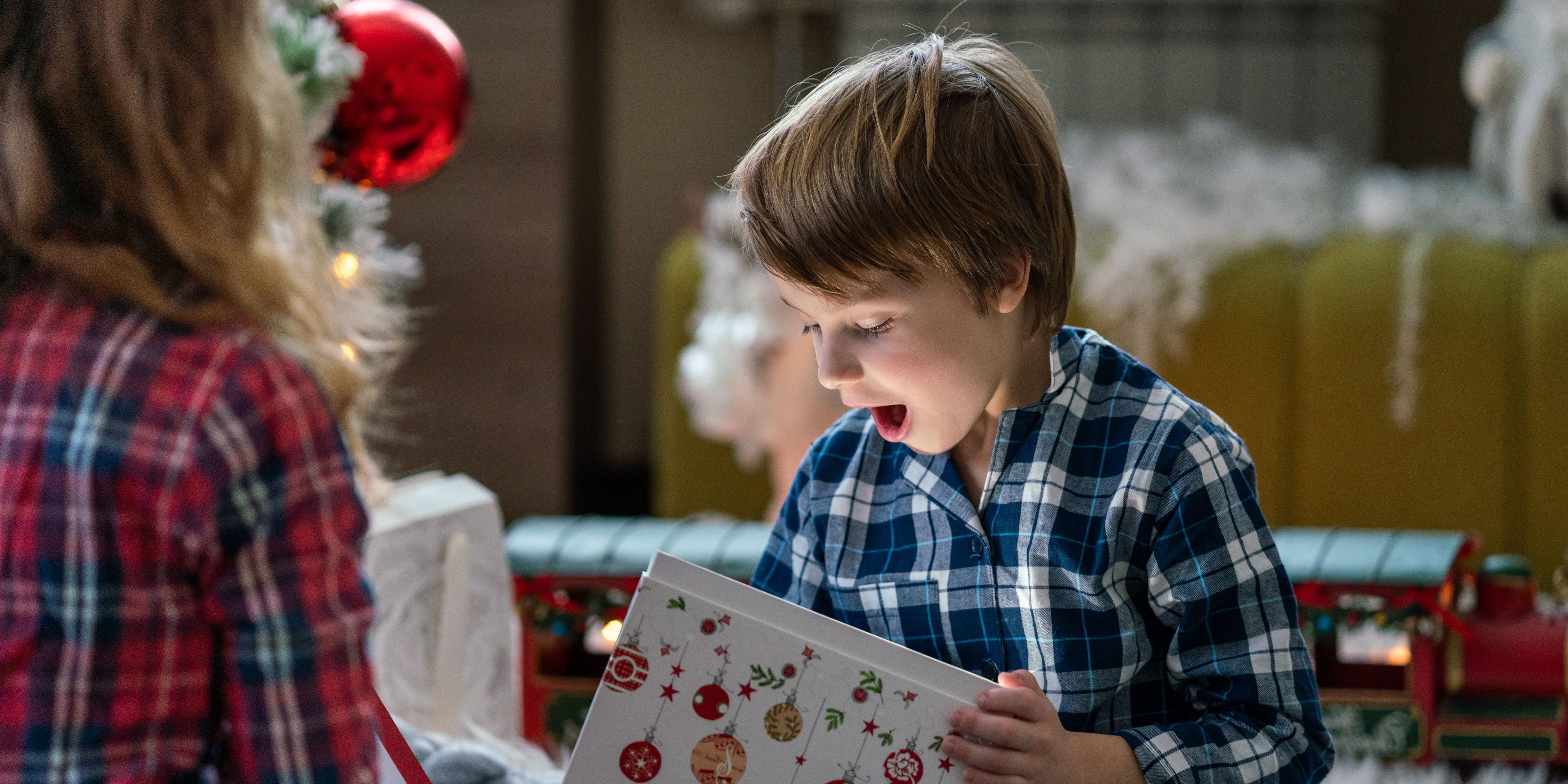 Suprised kid opening christmas present