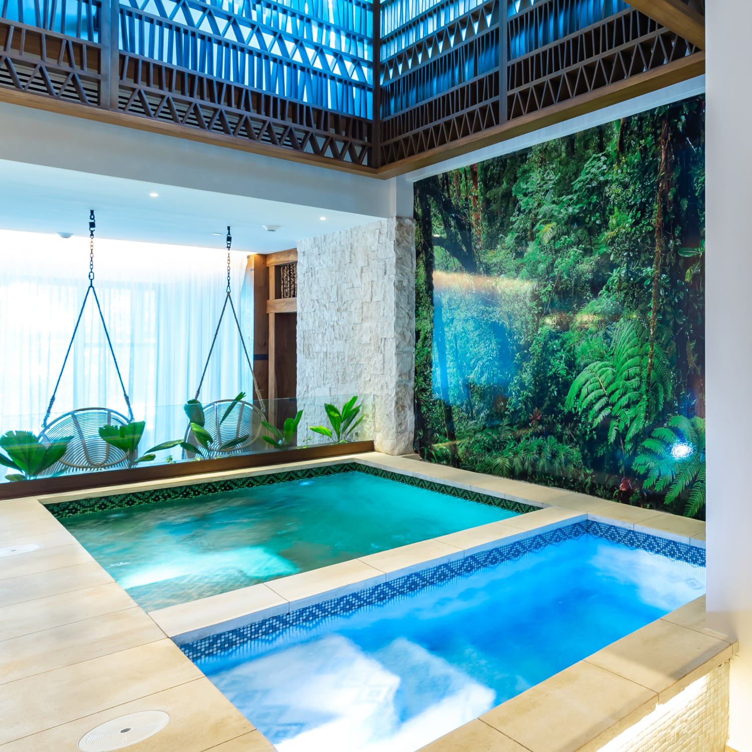 Soaking pools in a spa with lush vegetation in the background.