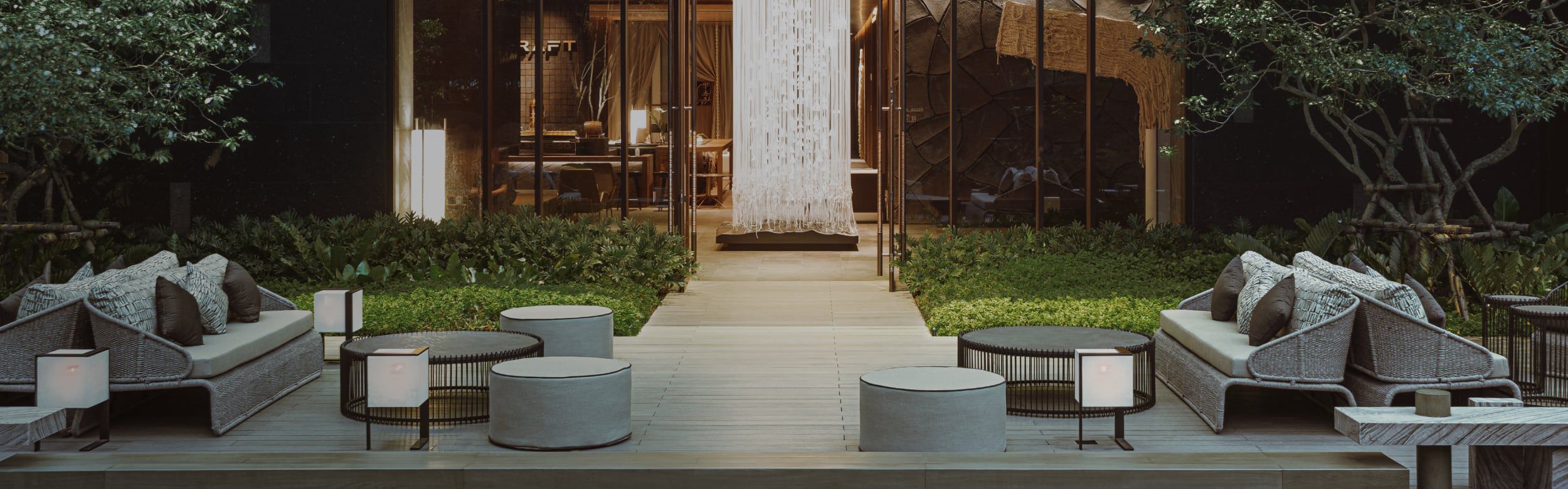 A raised sitting area with comfy sofas and ottomans for relaxing.