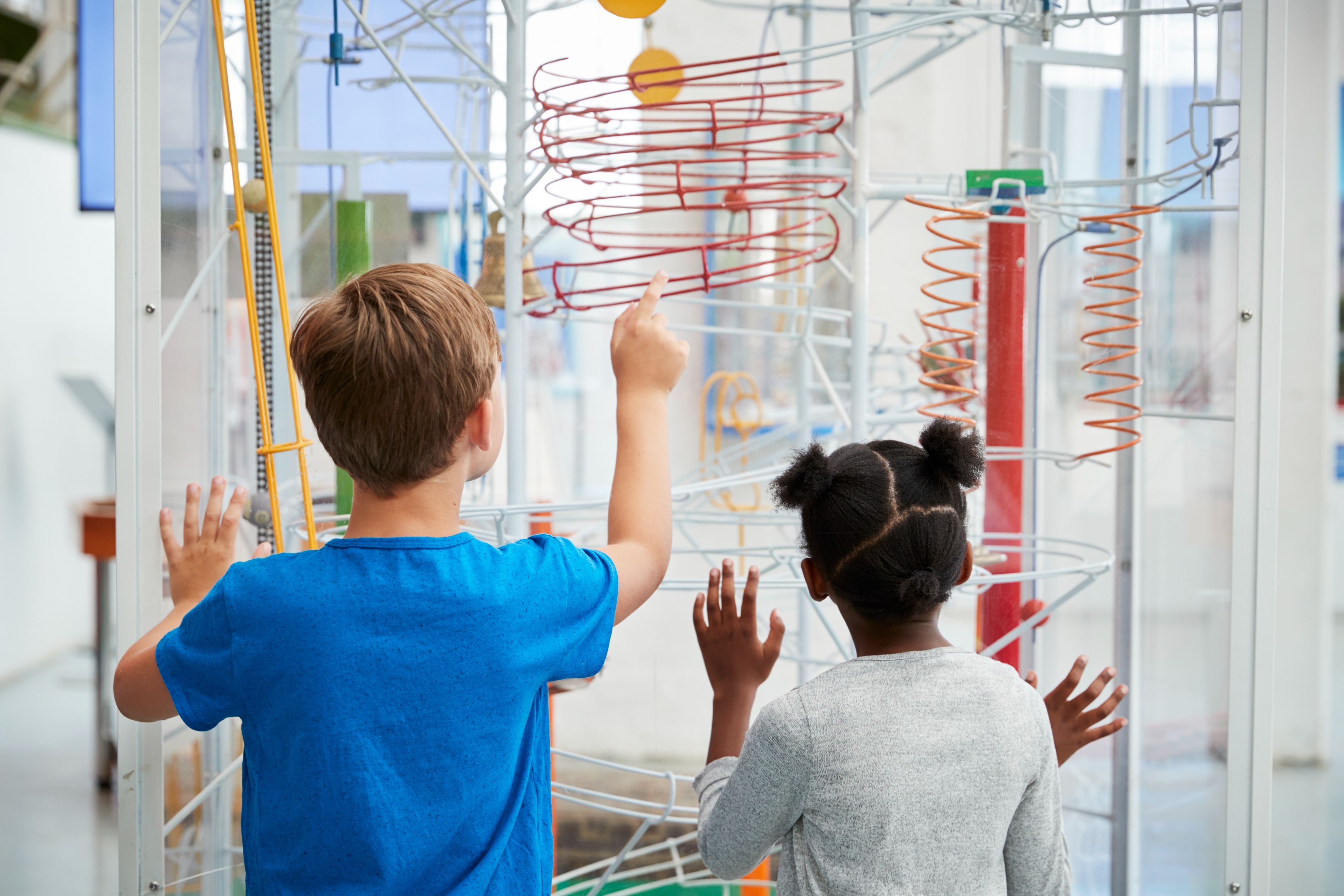 Kids looking at an attraction at a science museum.