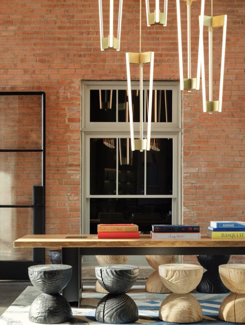 lobby living room with stool seating against an exposed brick wall