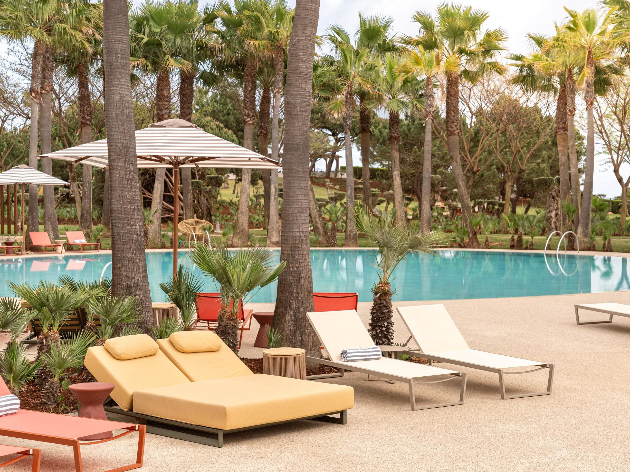 Relax under the palms, by the outdoor pool