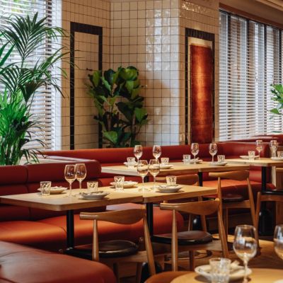 Gather over bold flavours in NENI Centrum's warm, stylish setting.