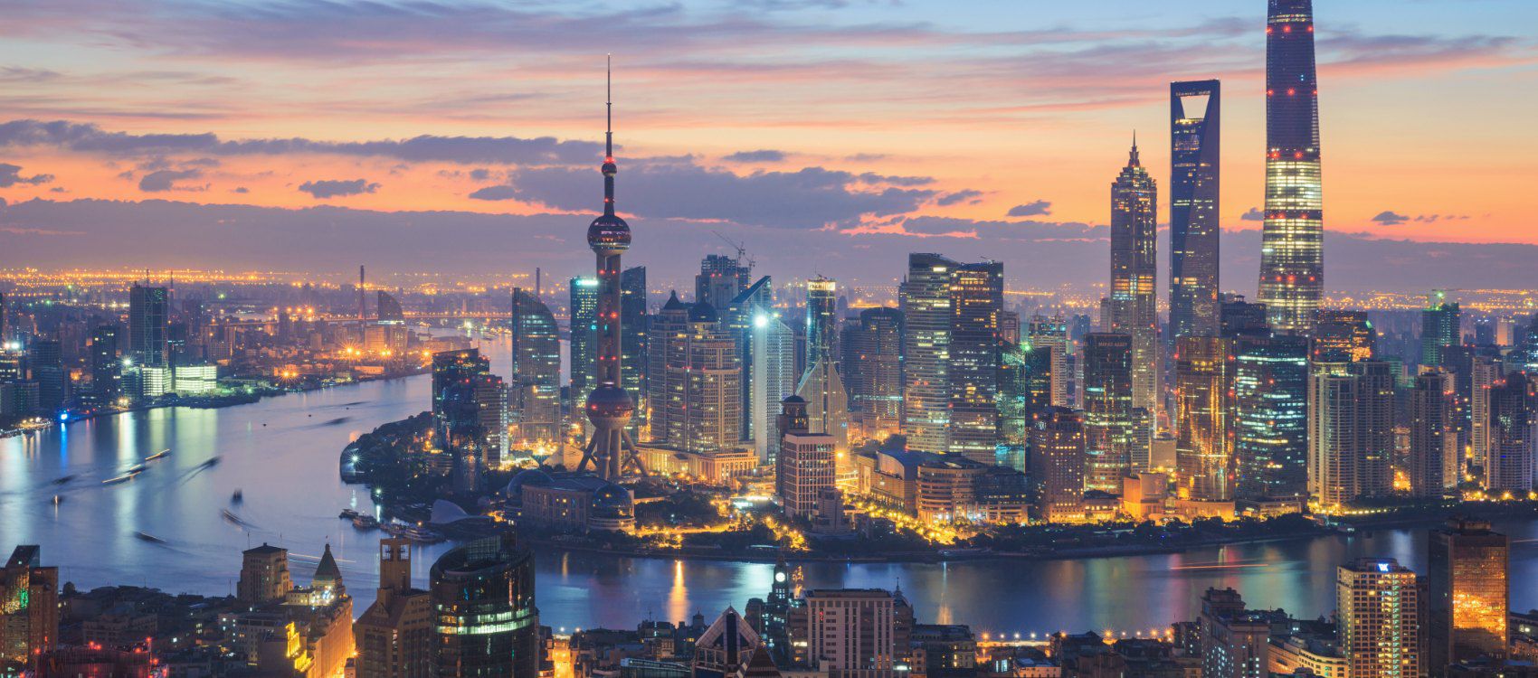 Shanghai city scape at nitght with river running through the city 
