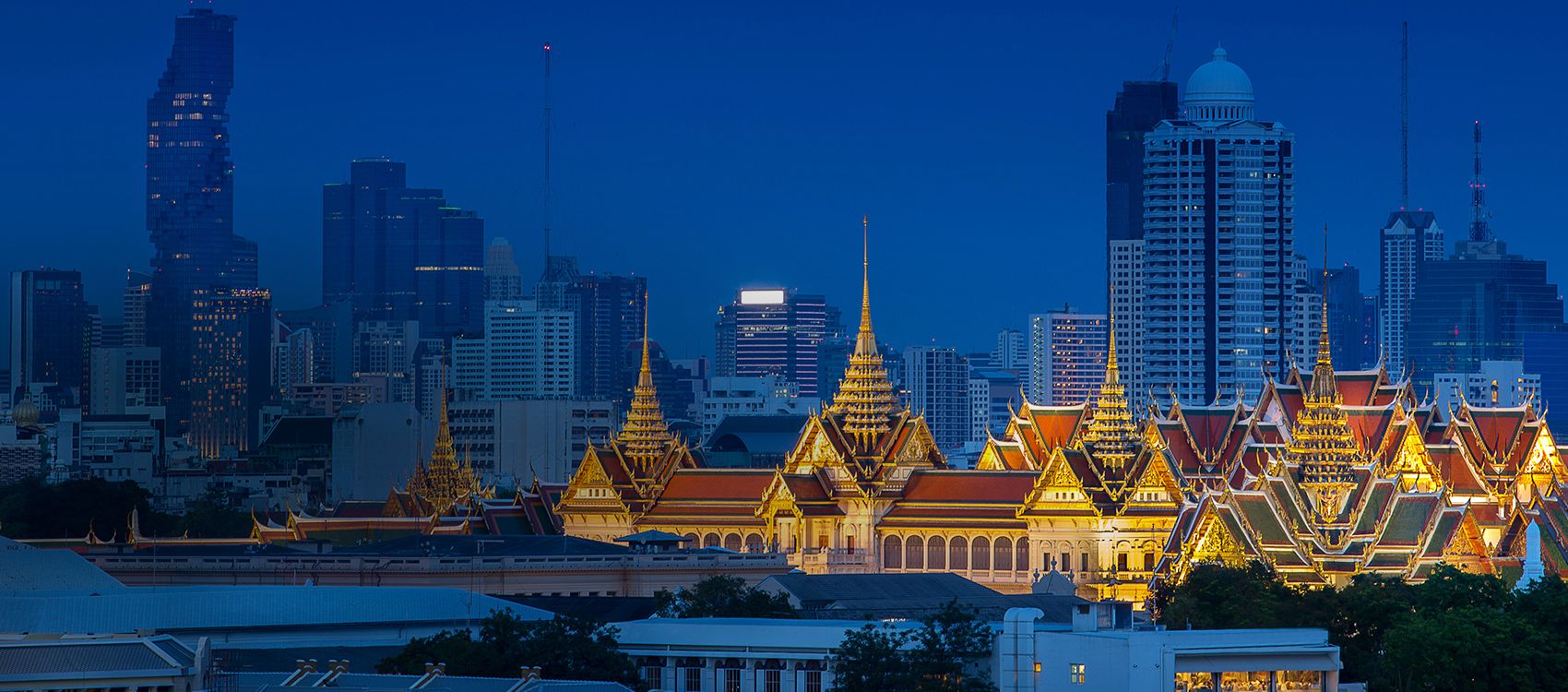 view of temple lit with golden lights against an otherwise dusky blue skyline