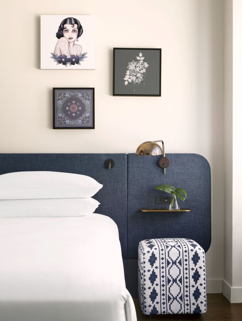 bed, headboard, and bed side table in blue and white decor