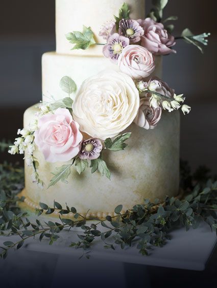 Three tiered wedding cake decorated with pale flowers