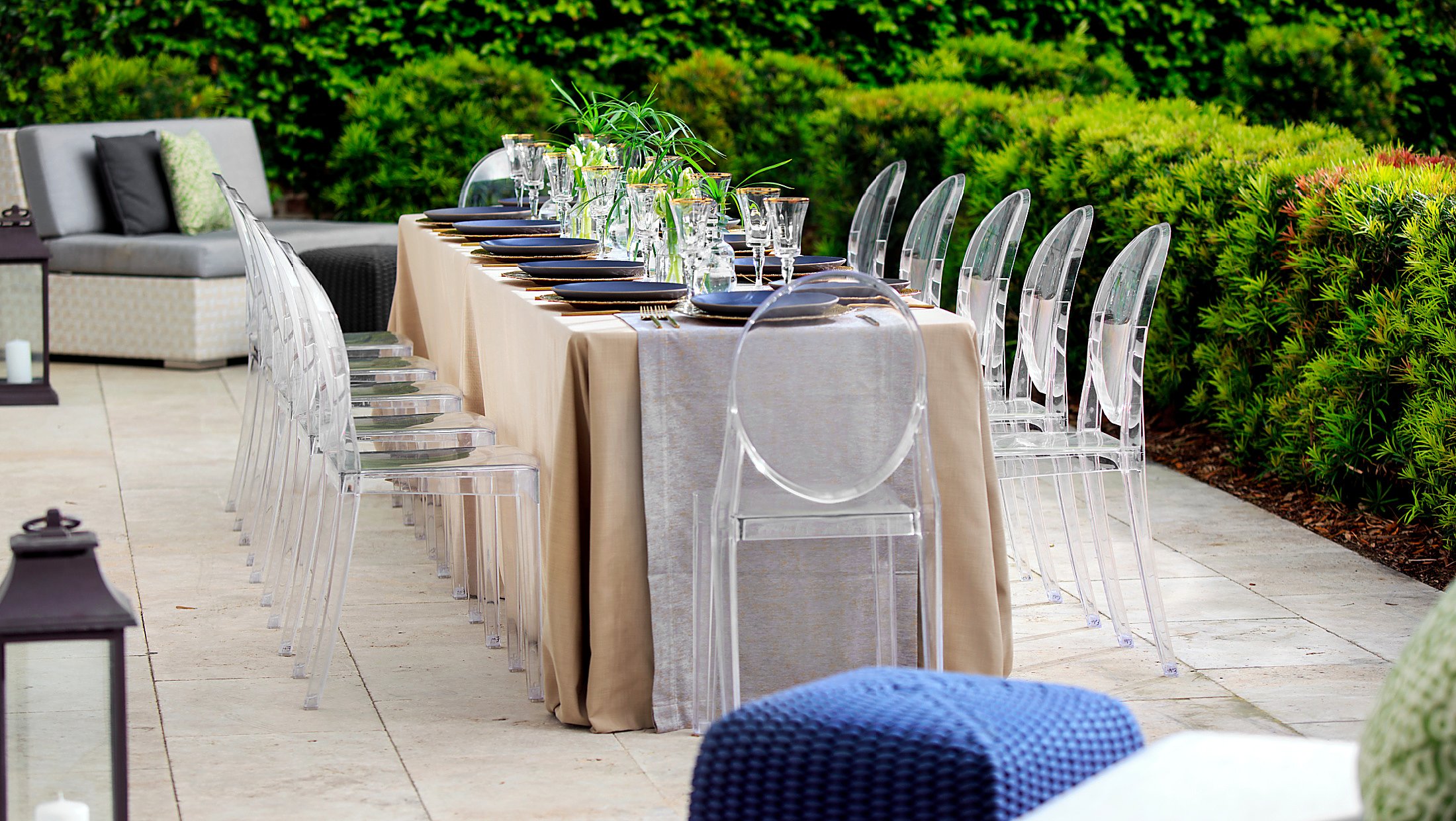 elegant table set for 12 on a lush outdoor patio