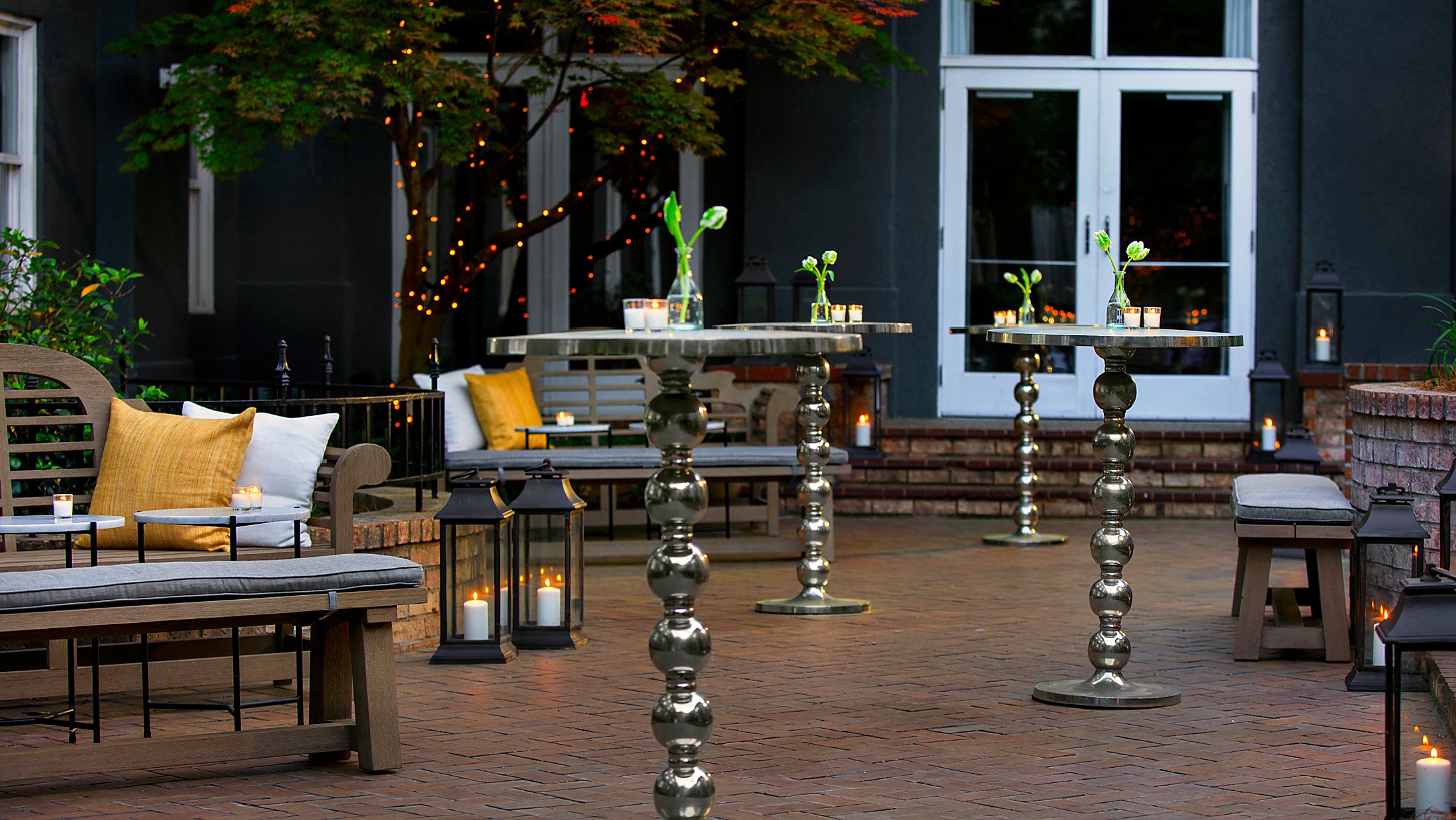 outdoor reception area with candlelit cocktail tables